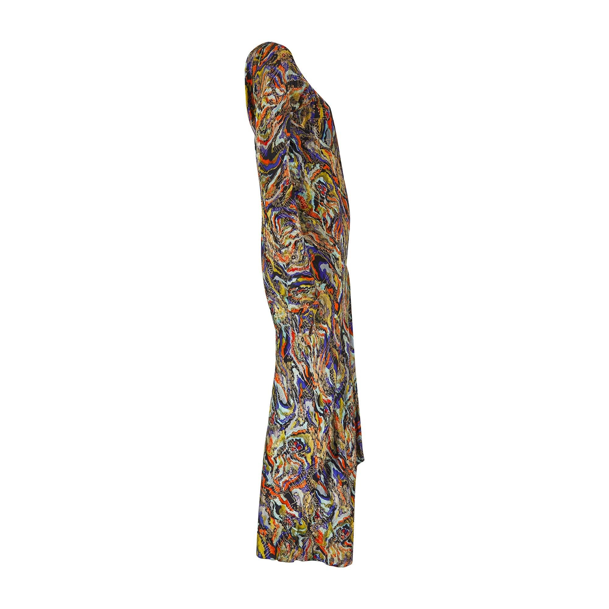 This striking and unusual 1930s lame gown is crafted from thick silk woven with a psychedelic pattern of black, pale-aqua, chartreuse and tangerine - bold hues that haven’t lost their vivacity. Atop these eye-catching colours, intricate abstract