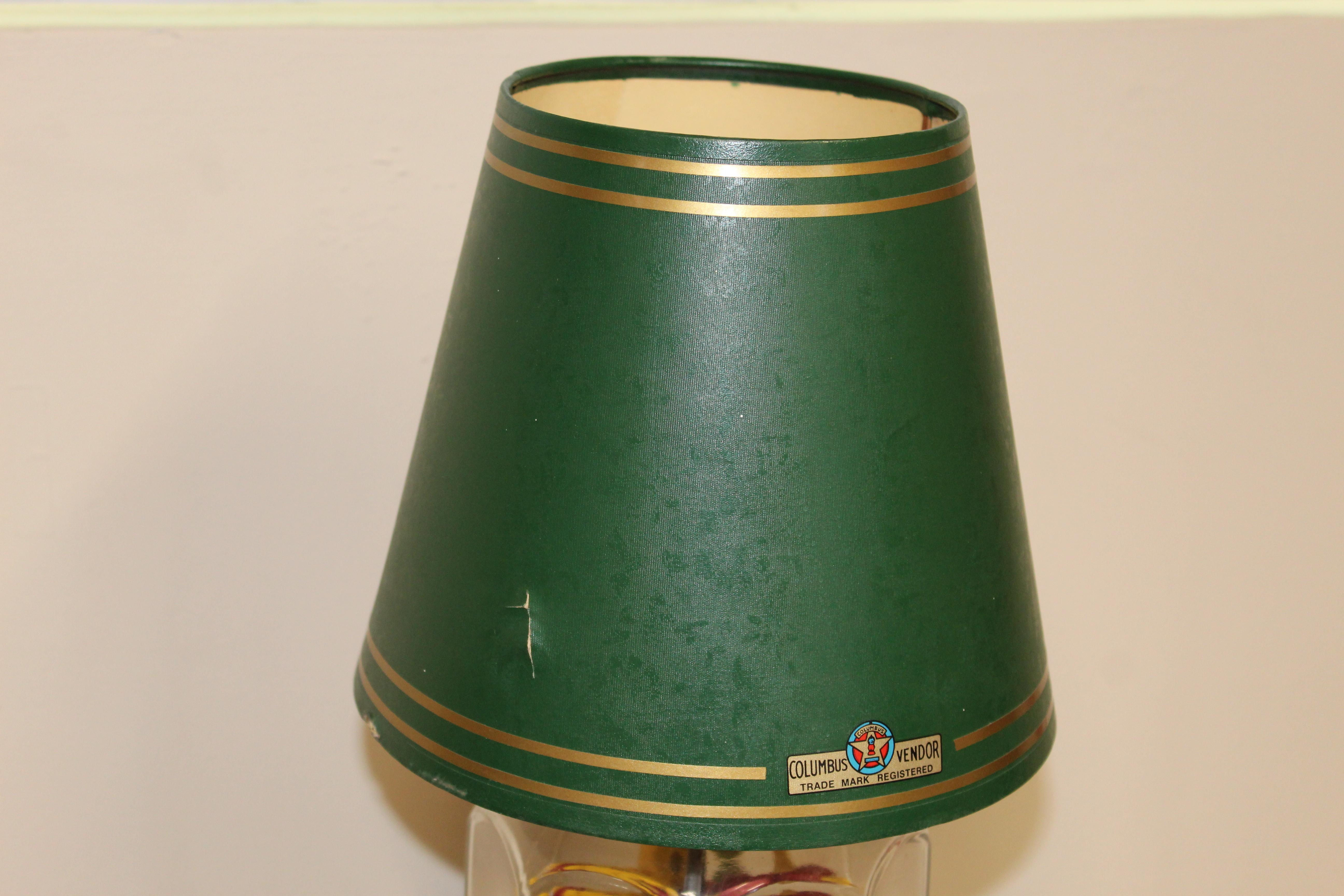Model 21 Columbus vending machine was originally made as a counter top lamp that was also a 1¢ vending machine. This unit even had ashtrays on both sides at the time, unfortunately that is missing on this item. Original mint color porcelain with