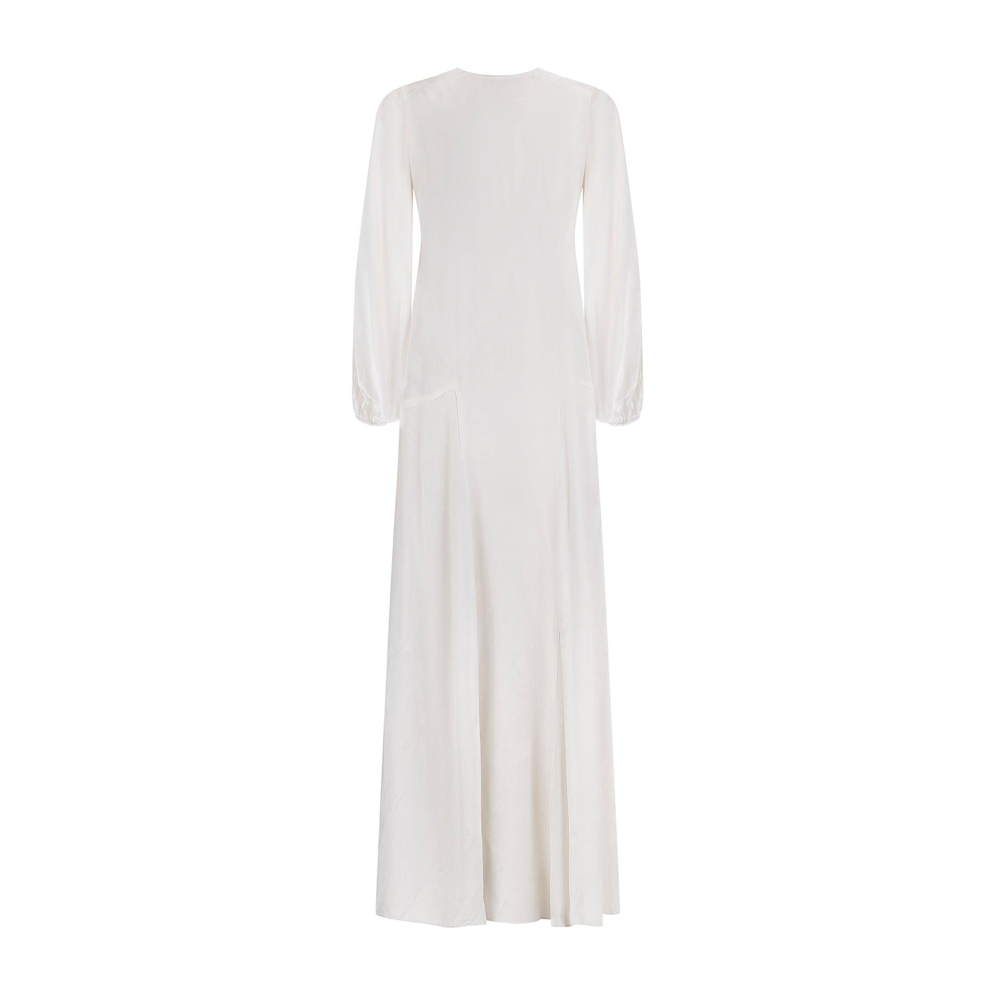 This 1930s gown would be a lovely wedding dress for fans of this decade, or perfect for anyone after an eye-catching gown for an upcoming event. It is crafted from white satin and falls to ankle length. The bias-cut creates a timeless, body-skimming