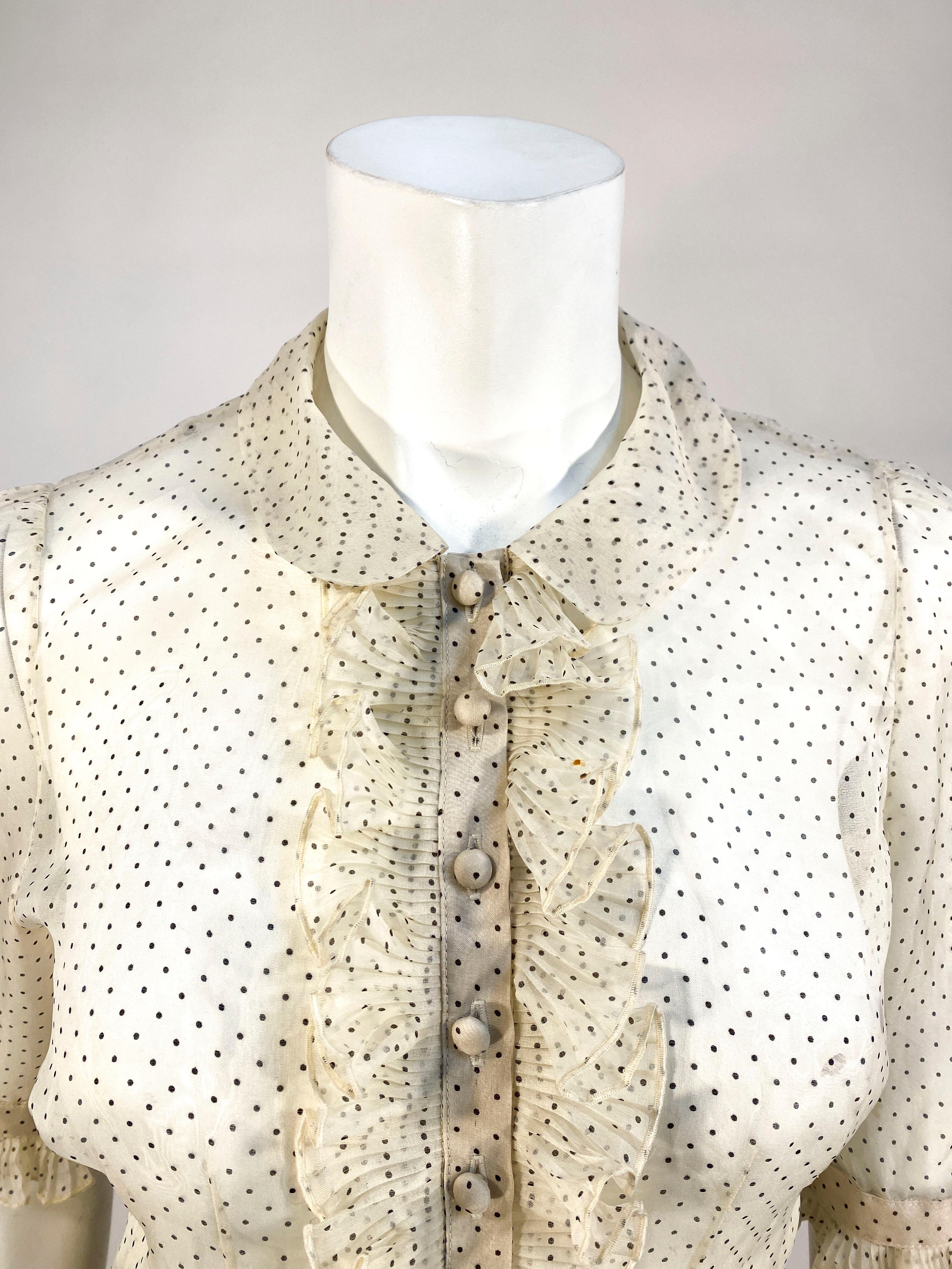 1930s cream colored sheer polkadot printed organza silk blouse with Peter Pan collar, gathered puff shoulders, hand covered buttons closure down the front and ruffles along the front, sleeve cuffs, and on the back 