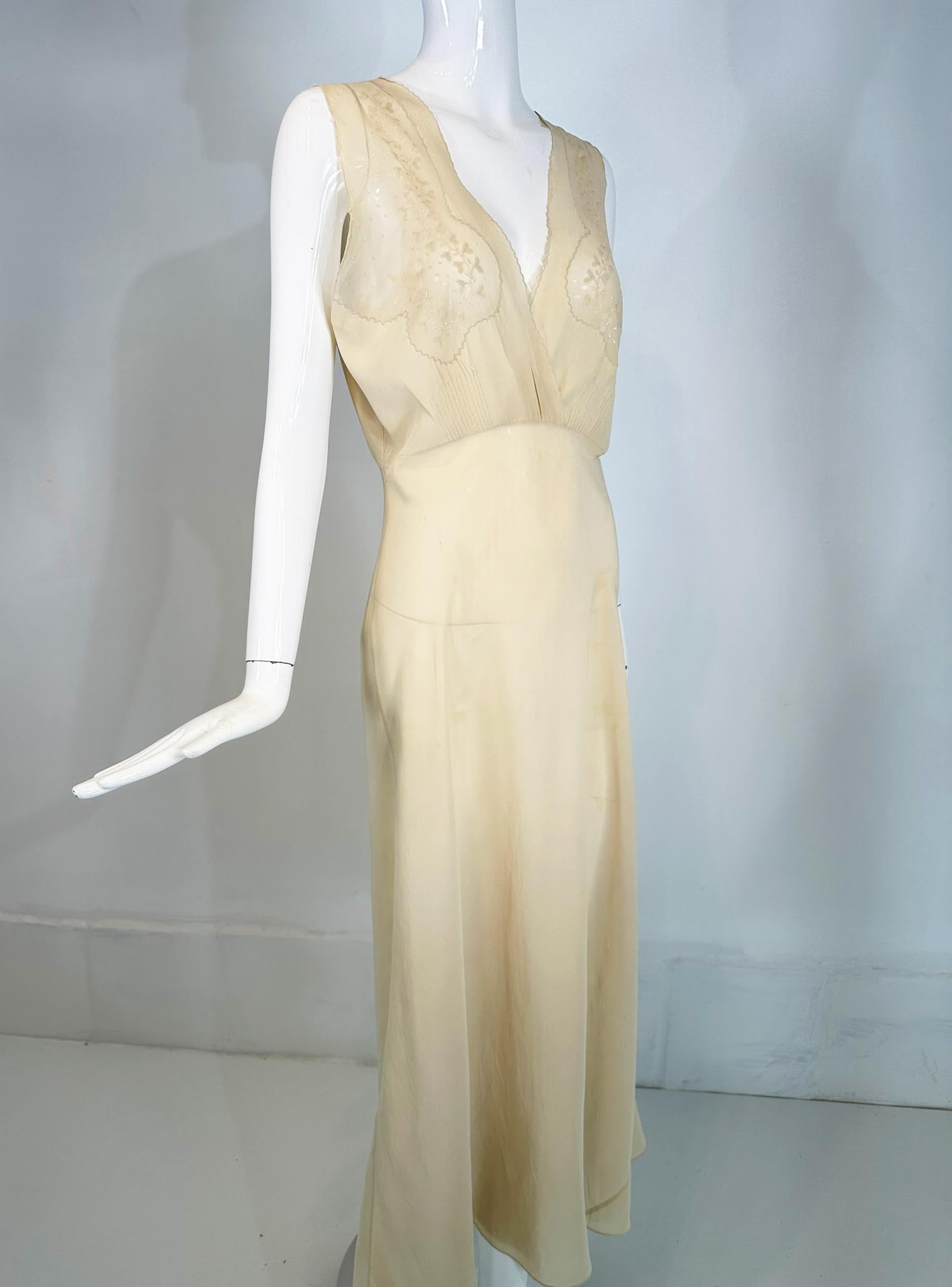 1930s cream bias cut sheer silk hand embroidered & appliqued slip dress gown. Beautiful sheer silk gown in pale cream. The cross over bodice has inset sheer silk panels at the bust, each with delicate applique & embroidery. The gown has a high