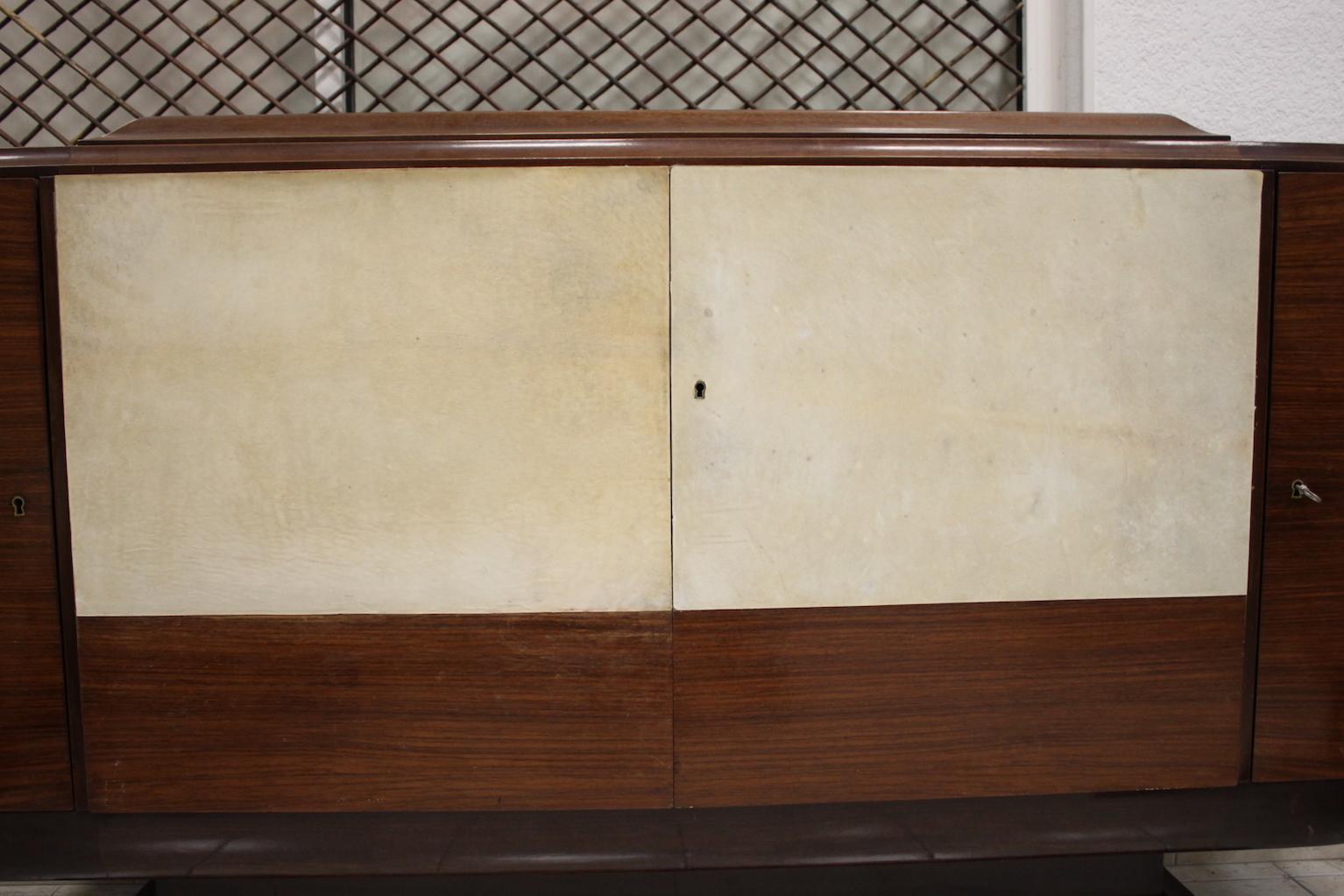 Credenza in veneer with parchment panels, probably made by 1930s designer. In perfect condition.
Dimensions: width 195 cm, depth 50 cm, height 105 cm.