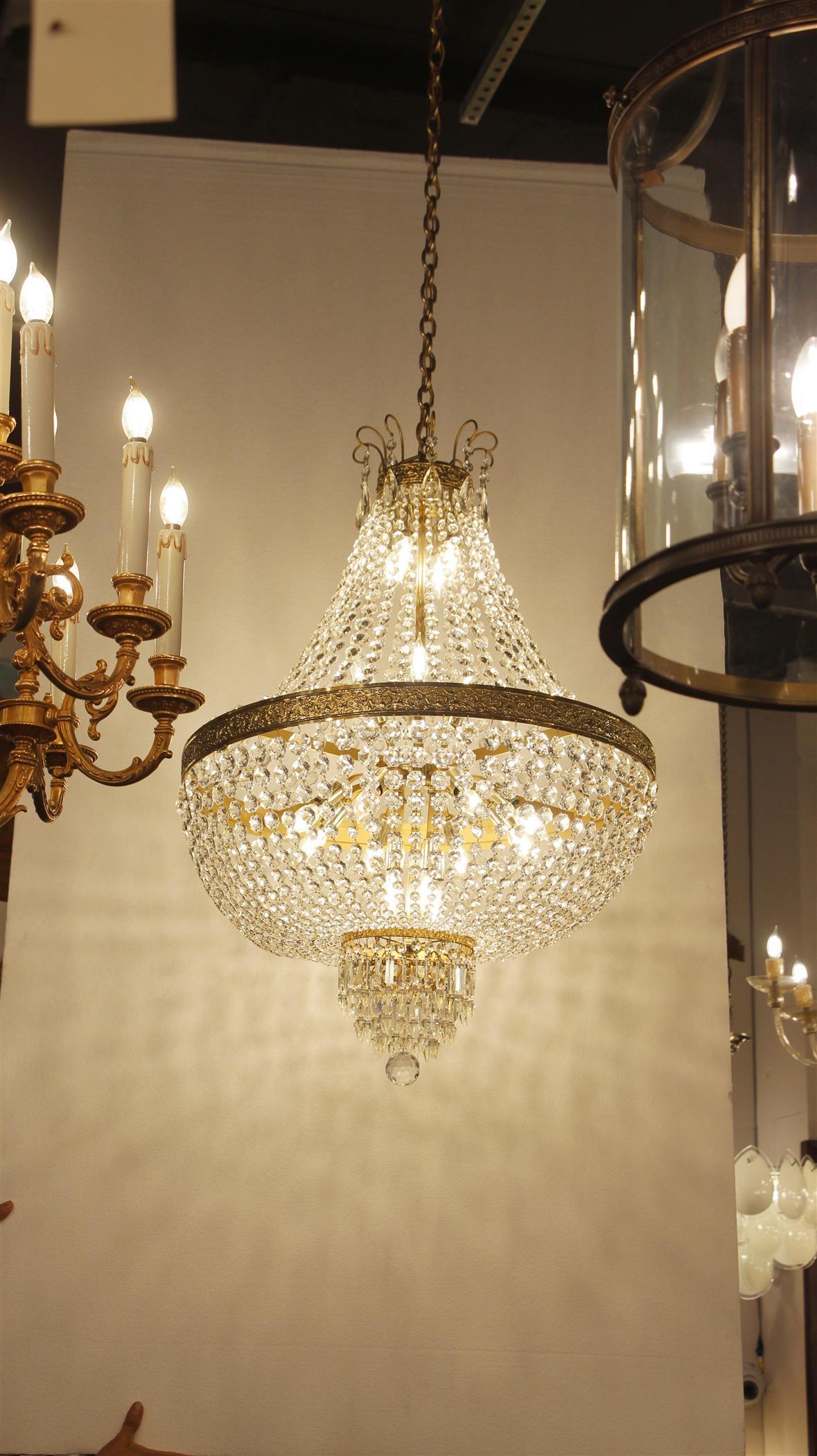 1930s gorgeous clear crystal basket chandelier with a decorative polished brass frame. This light has 20 bulbs total. From the Palace Theater on 42nd St in Manhattan. This can be seen at our 2420 Broadway location in Manhattan.