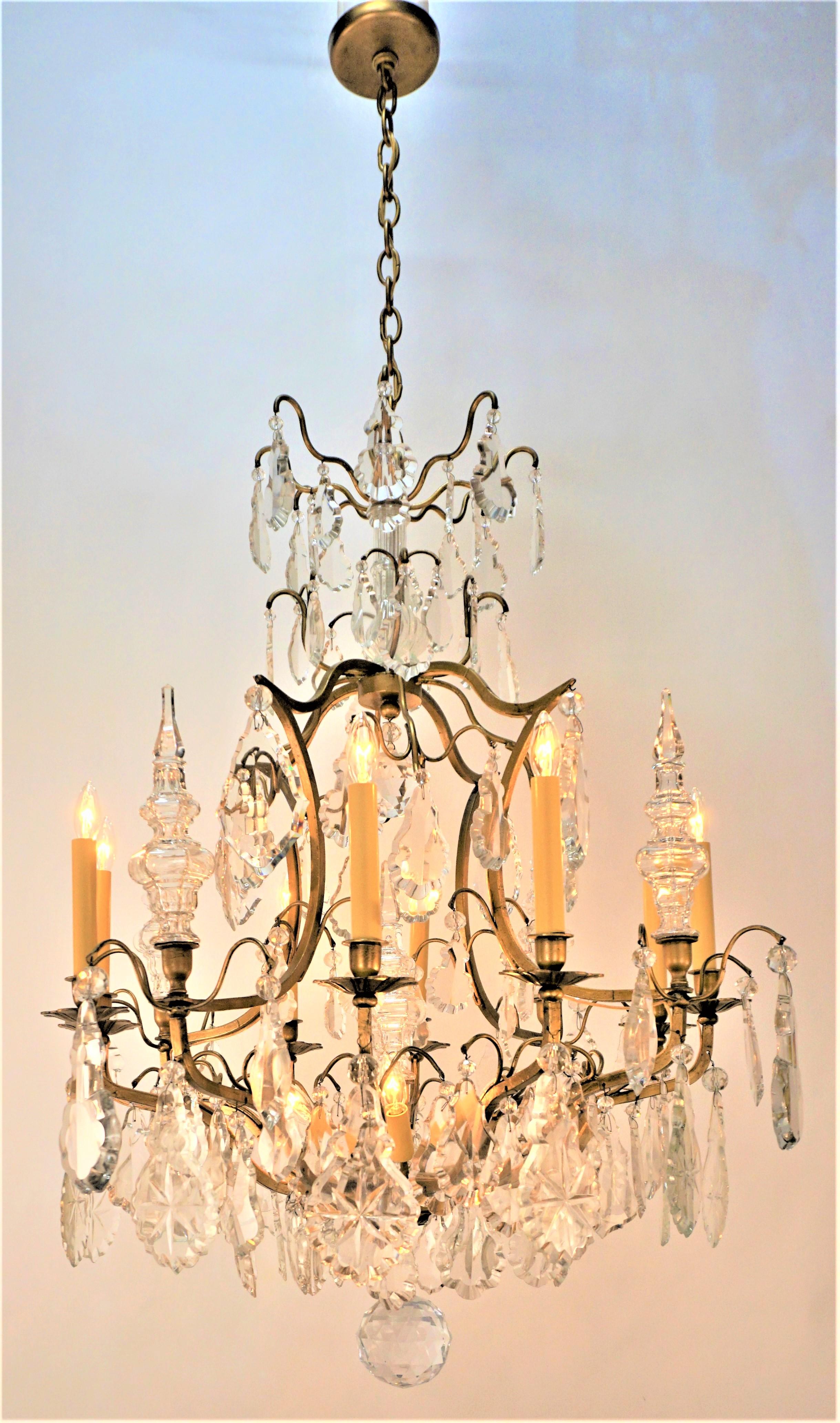Polished crystal gilt iron twelve light 1930s chandelier.
Measurement: width 28