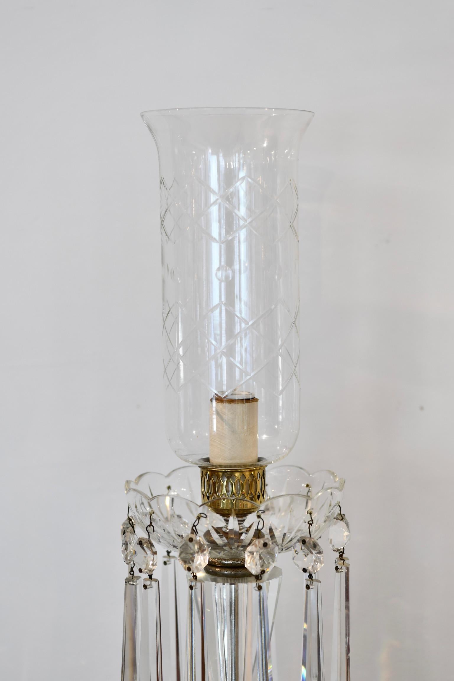 Crystal long prism and flare top hurricane lamp with lucite base, circa 1930. Prisms and hurricane are crystal. Hurricane has a small crack to the rim, pictured. Prisms have small but minor chips. Another lamp with one missing prism also available,