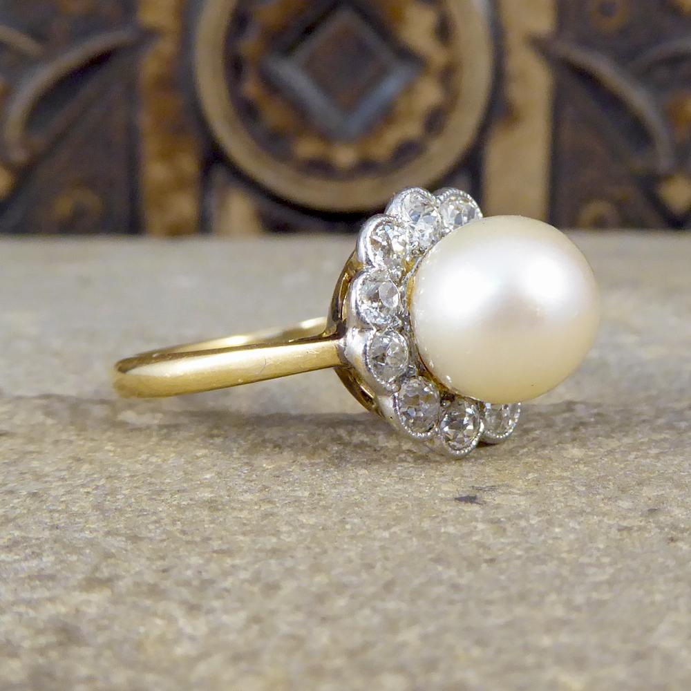 Such a beautiful 1930's ring, modelled in 18ct Yellow Gold with a White Gold setting. The ring features a Cultured Pearl that stands high from the finger with a Diamond Cluster circling the Pearl. 

Diamond Details:
Cut: Old European Cut
Carat: