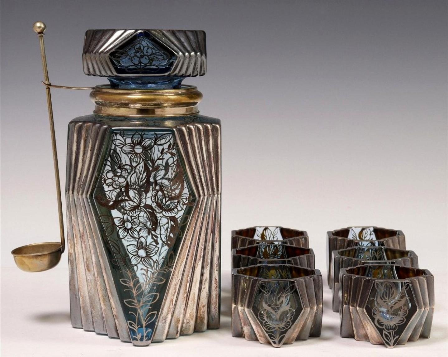 A spectacular period Art Deco Czechoslovakian art glass silver overlay liqueur service set.

Add a touch of refined elegance, warmth and sophistication to any bar with this fine quality hand-blown Bohemian (present day Czech Republic) liqueur set,