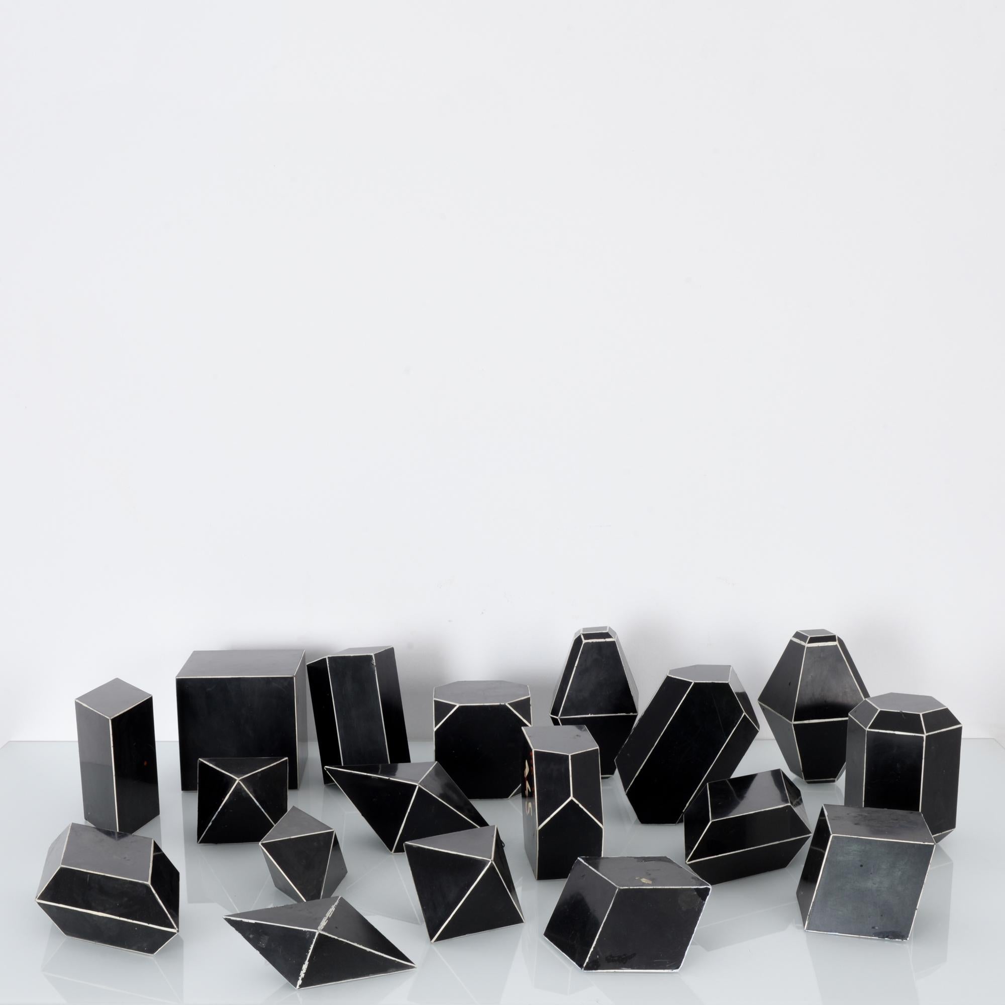 Crystal models from Czechia, circa 1930, made from Bakelite, an early synthetic plastic. Originally used in science classrooms, each depicts a different crystal structure. The bakelite is a deep black color; the edges of the shapes are delineated