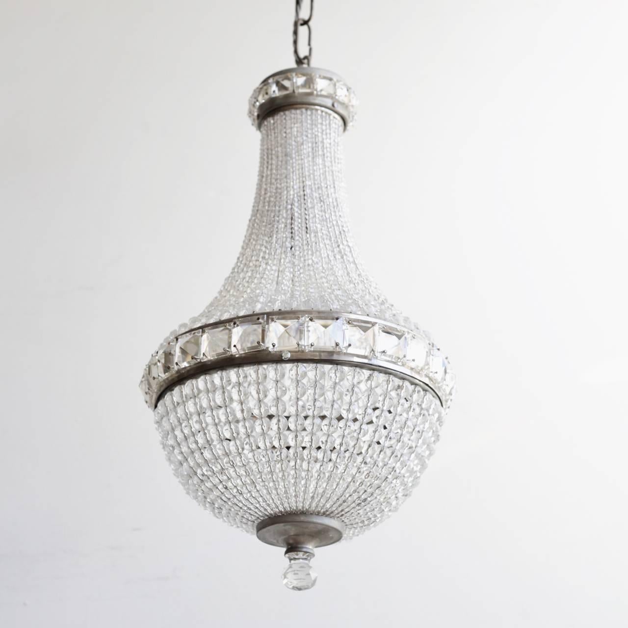 This crystal balloon chandelier originates from 1930s Czechoslovakia. The chandelier is in immaculate condition retaining all of its original Czech crystal. The main body of the chandelier is made from strings of ascending crystal beads. The frame