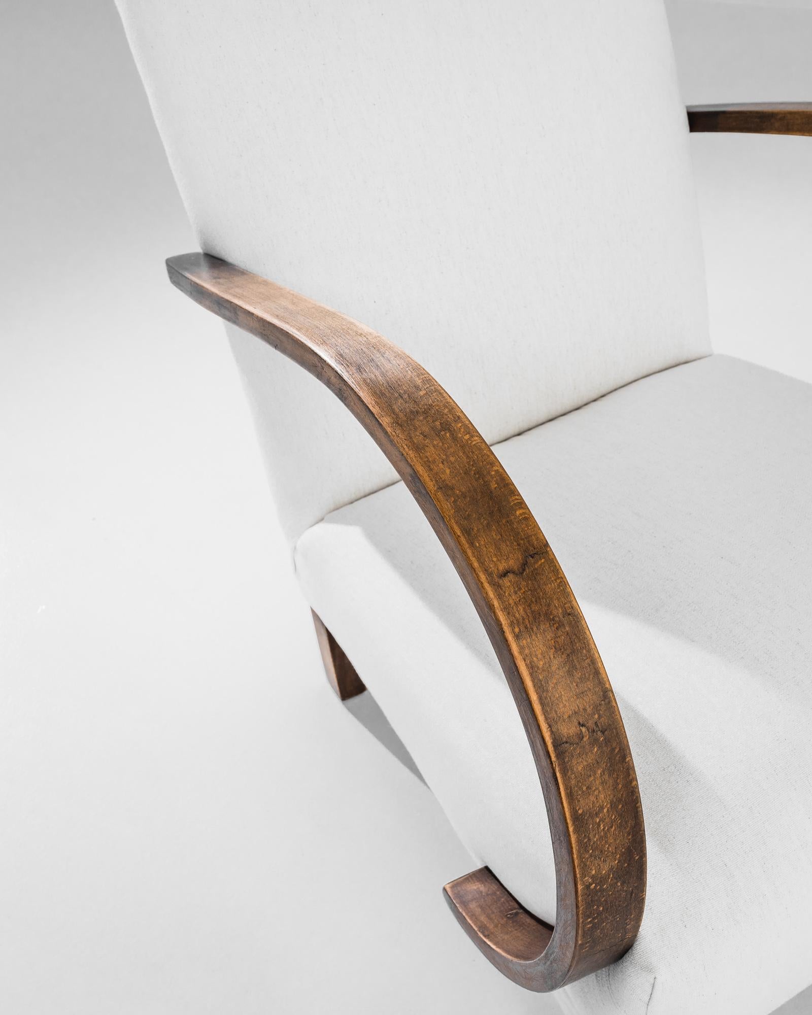 Add a touch of Art Deco elegance to your home with this stunning 1930s Czech Wooden Armchair by J. Halabala. Renowned for his innovative designs, Halabala's craftsmanship is evident in this exquisite piece, featuring gracefully curved wooden