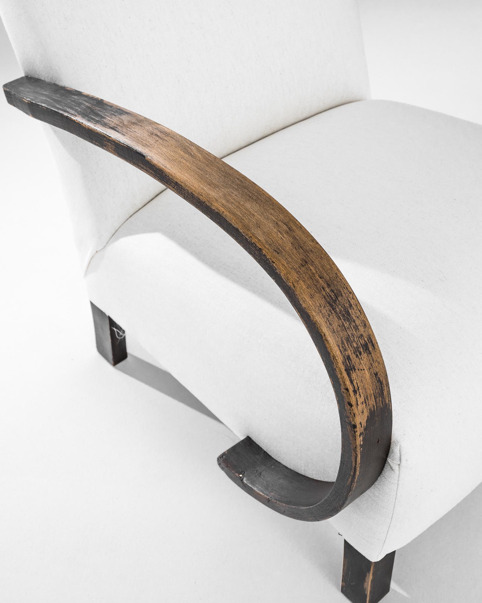 Add a touch of Art Deco elegance to your home with this stunning 1930s Czech Wooden Armchair by J. Halabala. Renowned for his innovative designs, Halabala's craftsmanship is evident in this exquisite piece, featuring gracefully curved wooden
