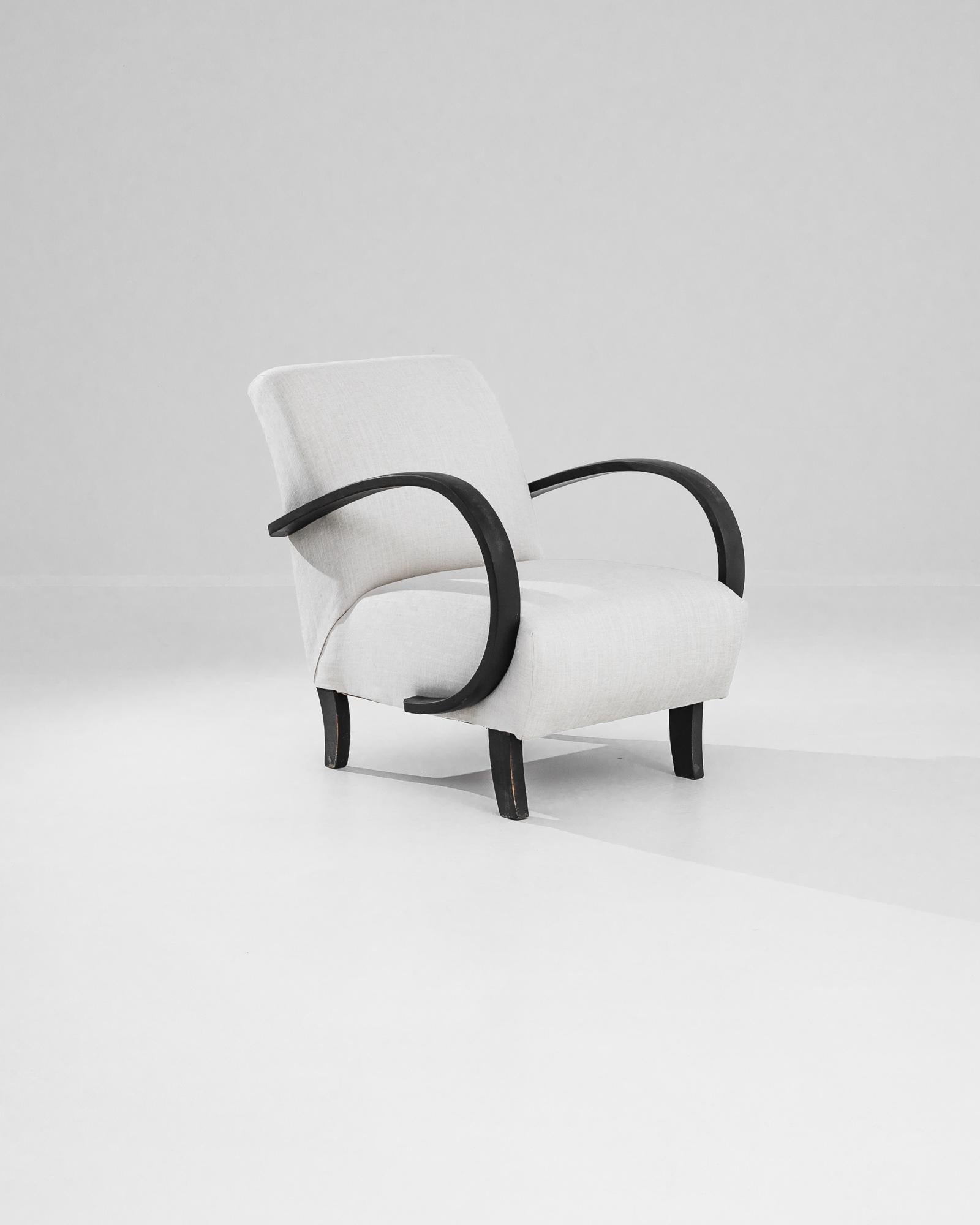 Add a touch of Art Deco elegance to your home with this stunning 1930s Czech Wooden Armchair by J. Halabala. Renowned for his innovative designs, Halabala's craftsmanship is evident in this exquisite piece, featuring gracefully curved wooden