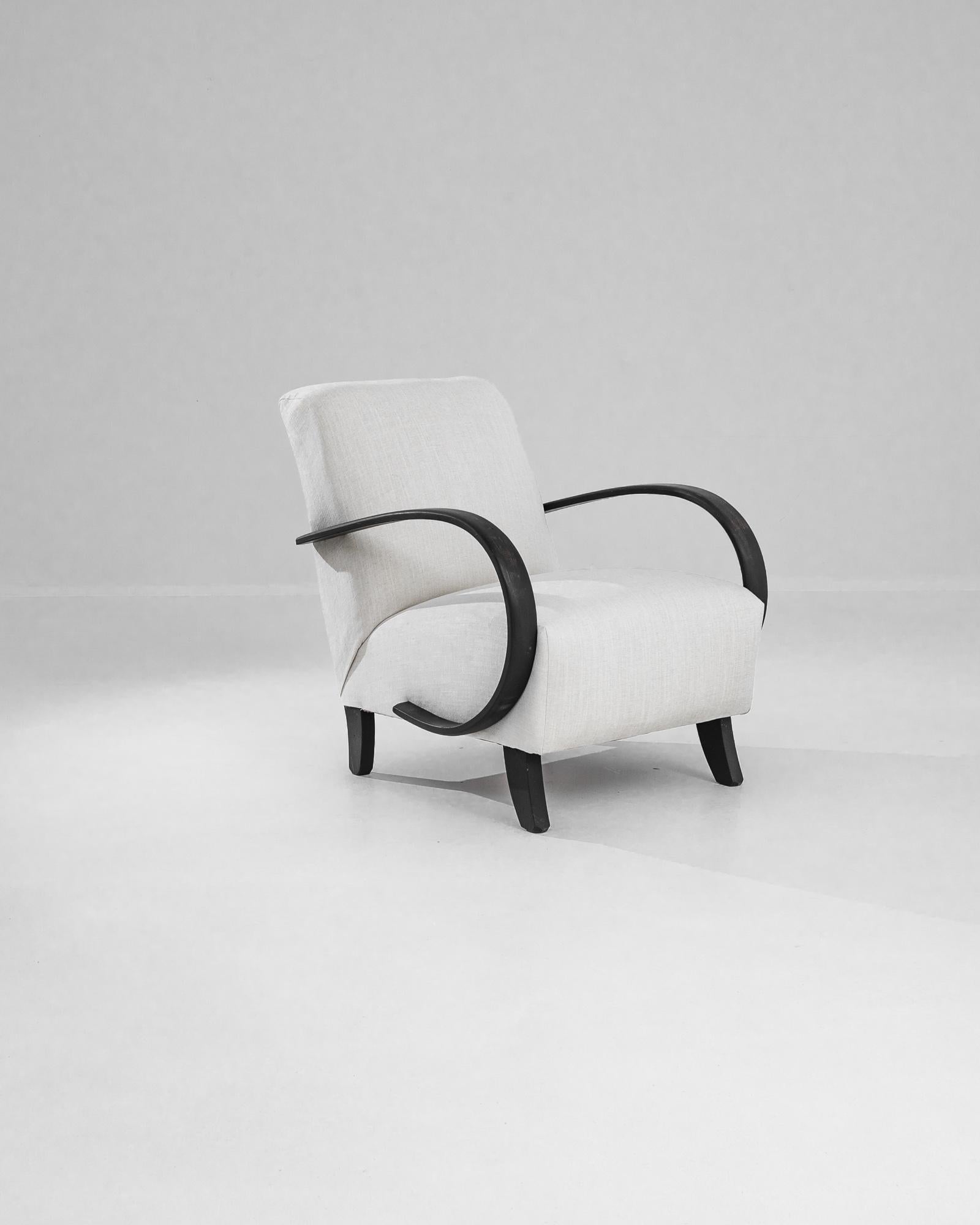 Add a touch of Art Deco elegance to your home with this stunning 1930s Czech Wooden Armchair by J. Halabala. Renowned for his innovative designs, Halabala's craftsmanship is evident in this exquisite piece, featuring gracefully curved wooden