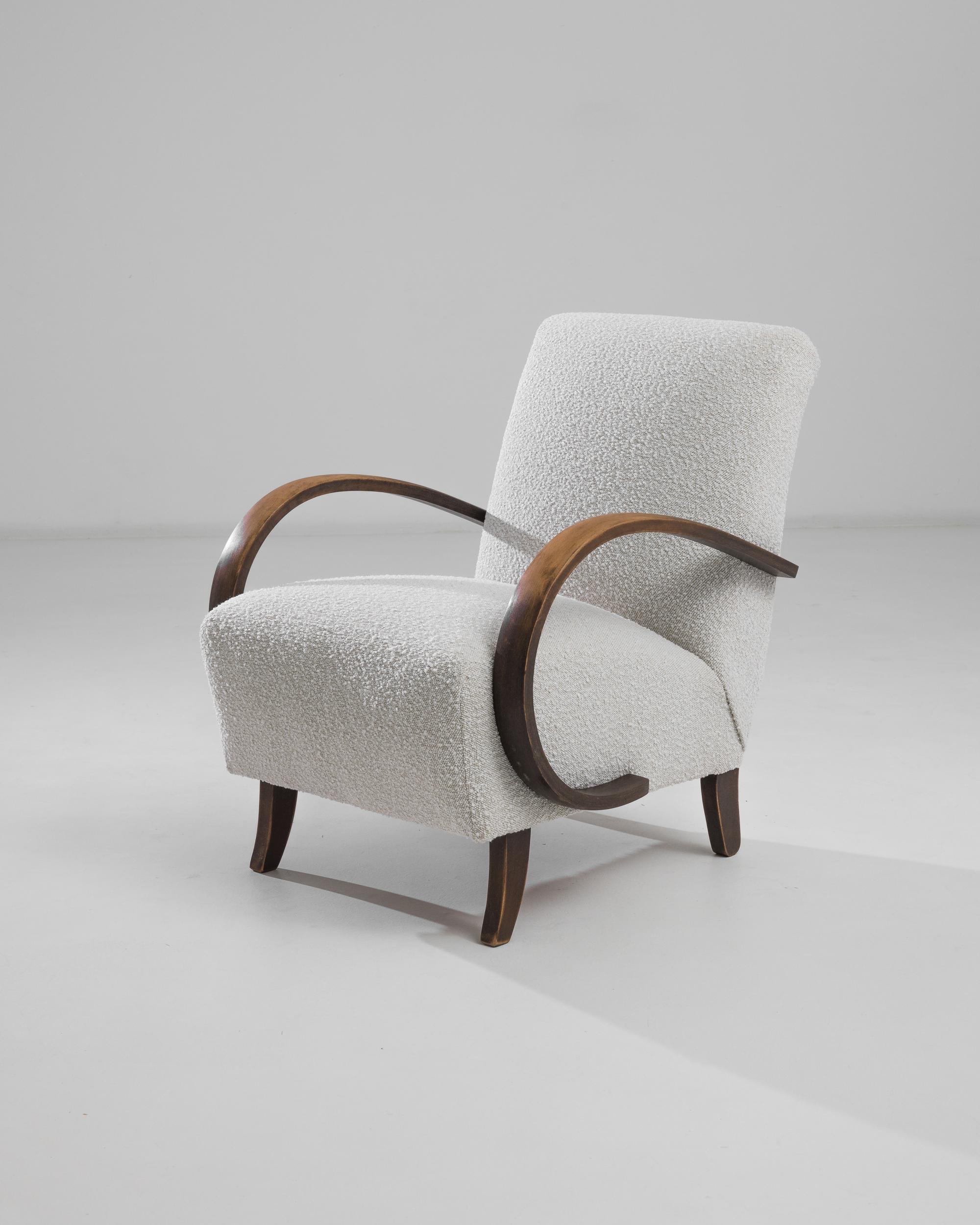 Introducing the 1930s Czech Wooden Armchair by J. Halabala, a timeless piece that combines vintage charm with modern comfort. This exquisite armchair features elegantly curved wooden armrests that provide a striking contrast to its plush, textured