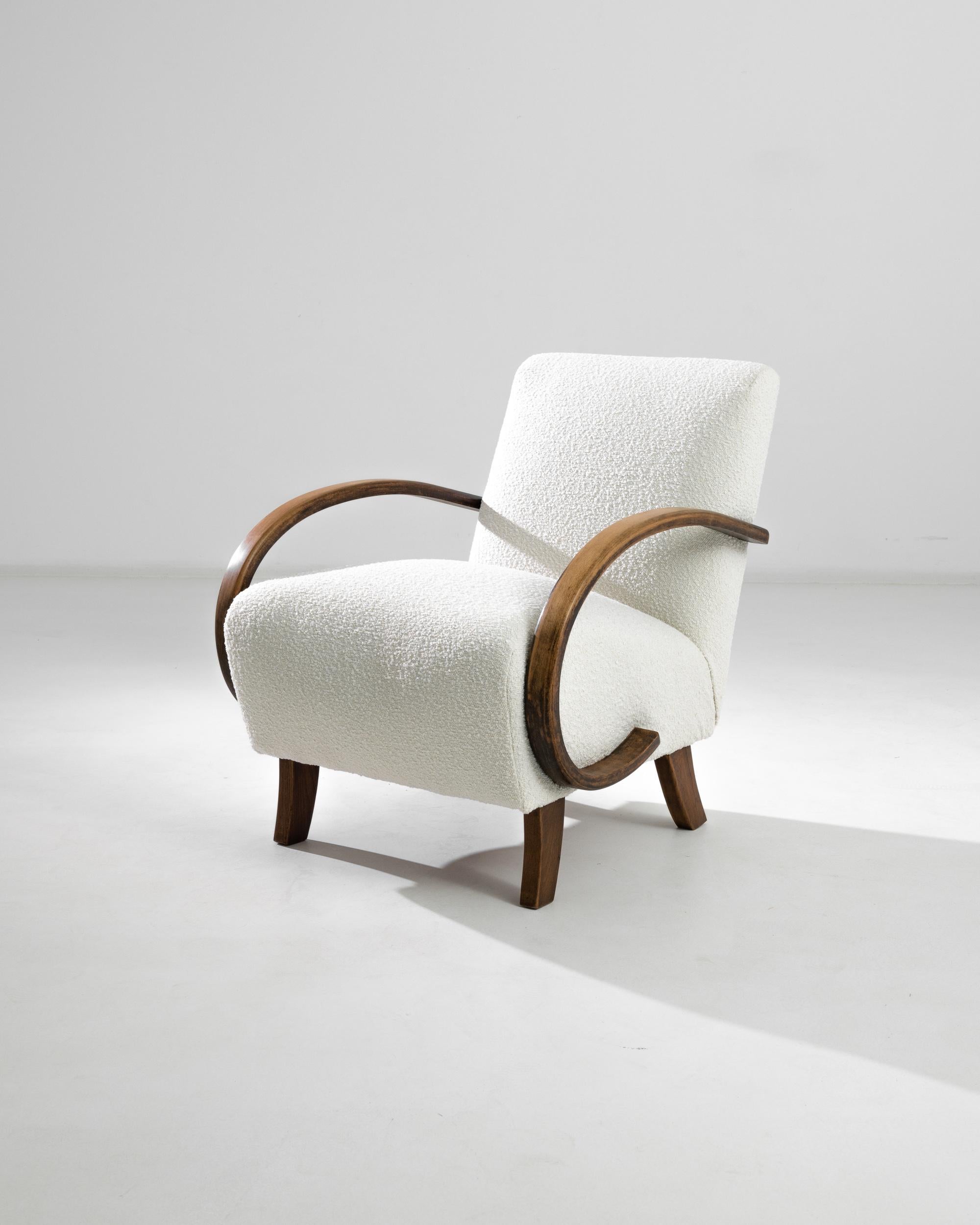 Elevate your living space with this exquisite 1930s Czech Wooden Armchair by the renowned designer J. Halabala. This mid-century modern chairs boast a timeless elegance with their sleek lines and graceful curves. The sturdy wooden frame is