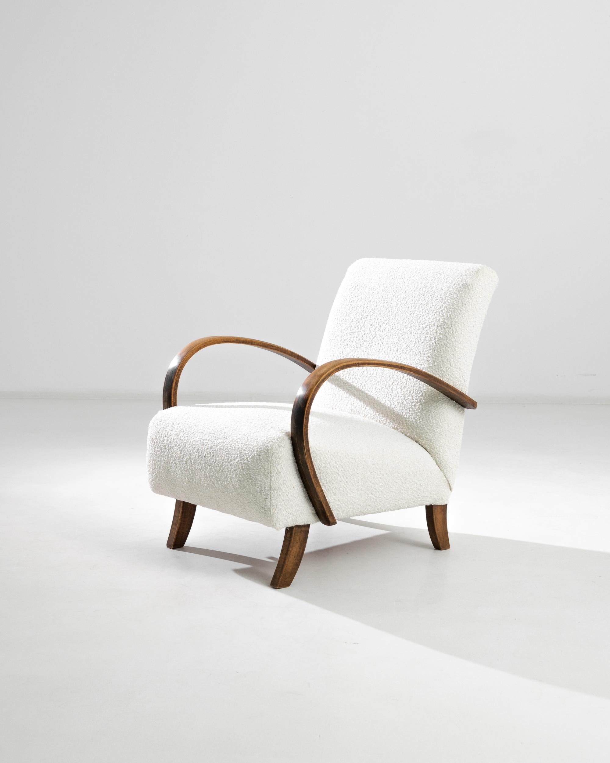 Elevate your living space with this exquisite pair of 1930s Czech Wooden Armchairs by the renowned designer J. Halabala. These mid-century modern chairs boast a timeless elegance with their sleek lines and graceful curves. The sturdy wooden frame is