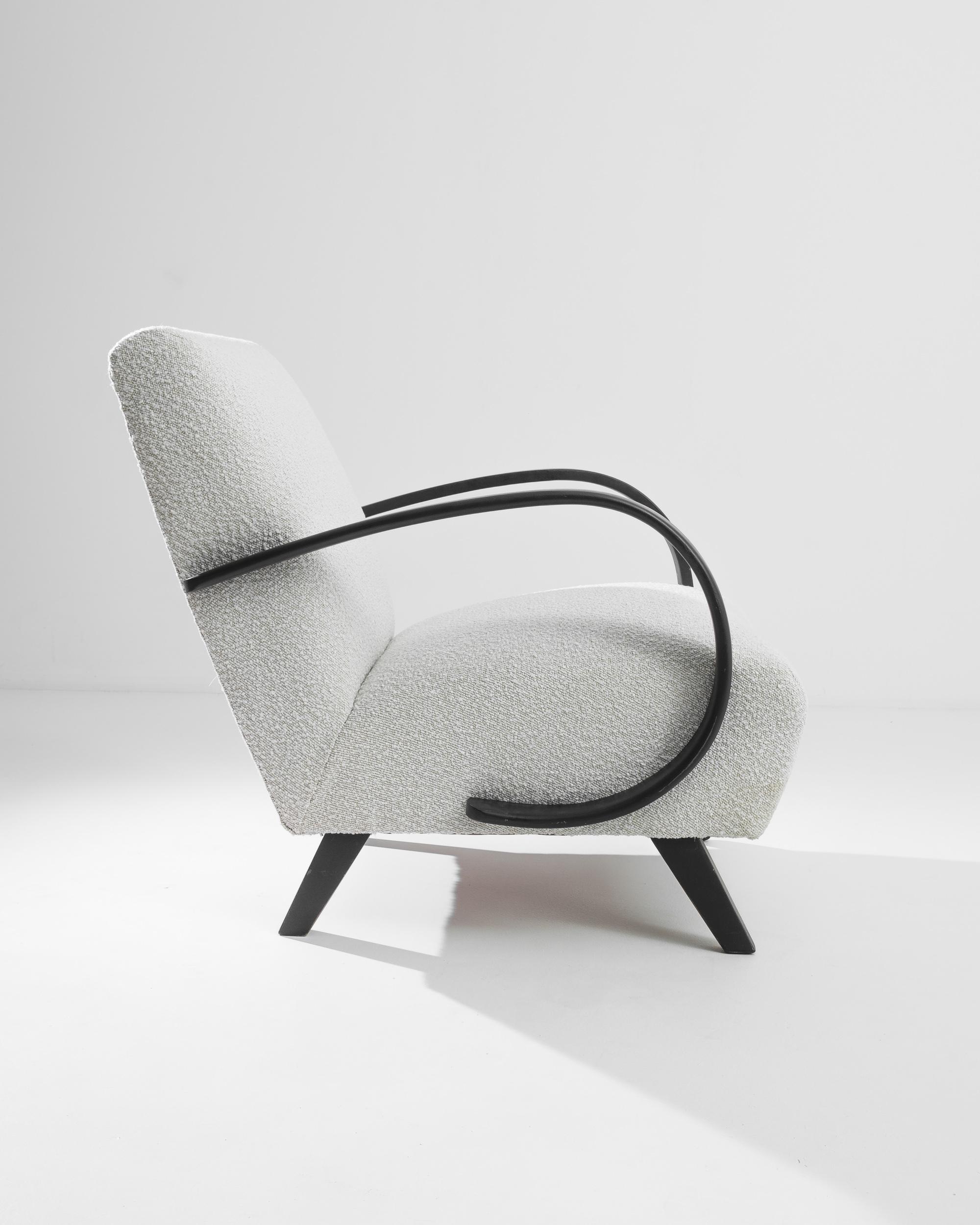 Step into the elegance of the 1930s with this exquisite Czech Wooden Armchair by J. Halabala. Renowned for its impeccable craftsmanship and timeless design, this armchair is a true collector's piece. The gracefully curved wooden arms and legs