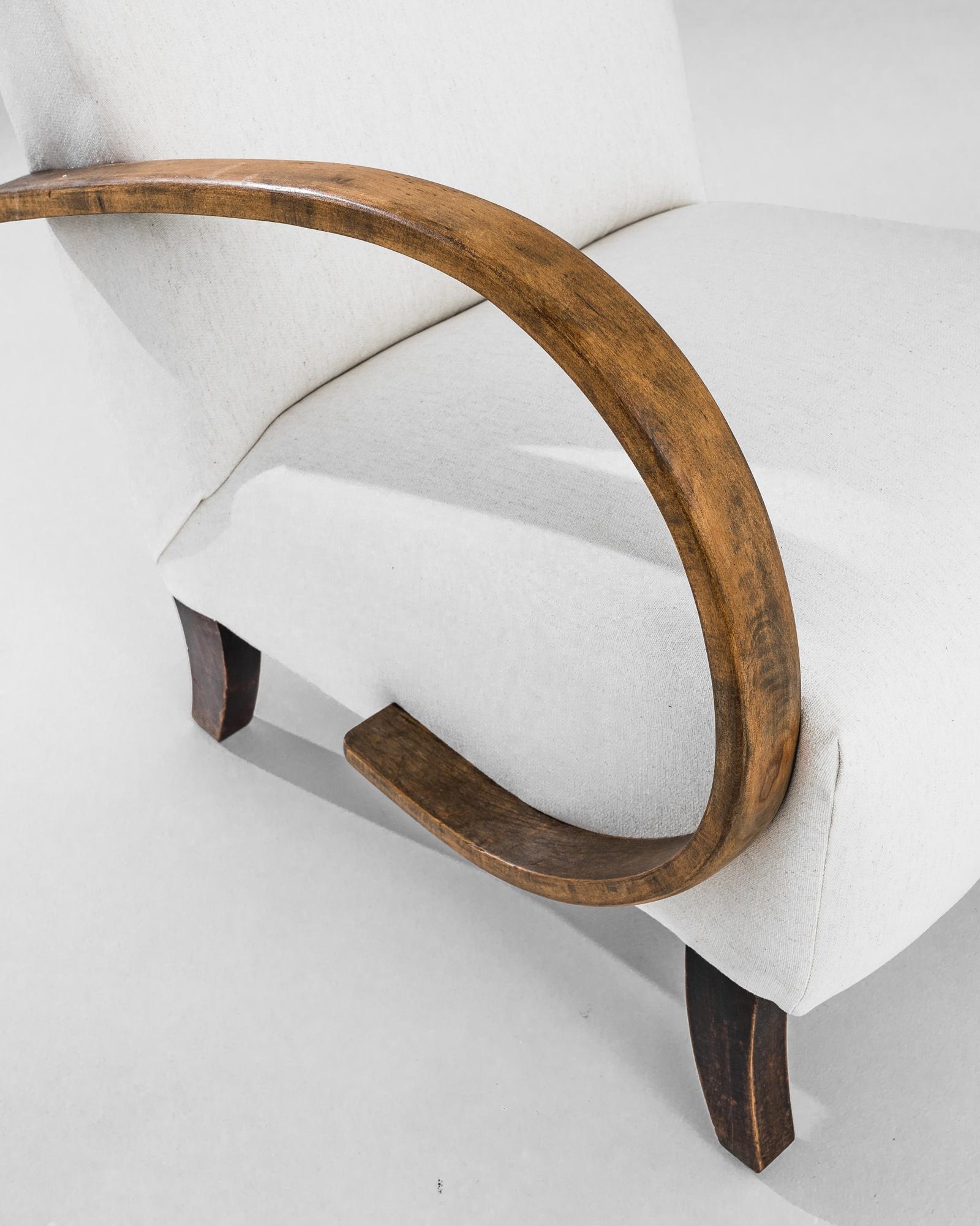 Scopri l'eleganza senza tempo di questa poltrona in legno ceca degli anni '1930, un capolavoro realizzato dal famoso designer J. Halabala. Questo squisito pezzo presenta una miscela perfetta di estetica moderna di metà secolo e di artigianato di