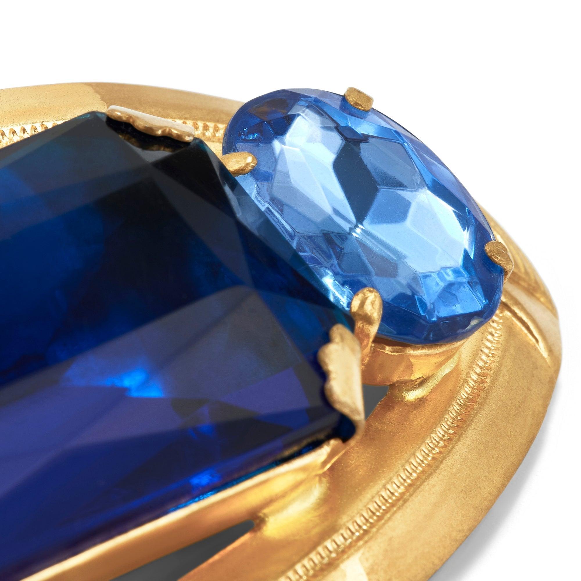 This large brooch is a real head-turner. Mostly likely designed in pre-war Czechoslovakia, so 1930s, it is crafted from a gold-toned metal and features flamboyant and very large glass stones. The central stone is a rich royal blue and cut to a