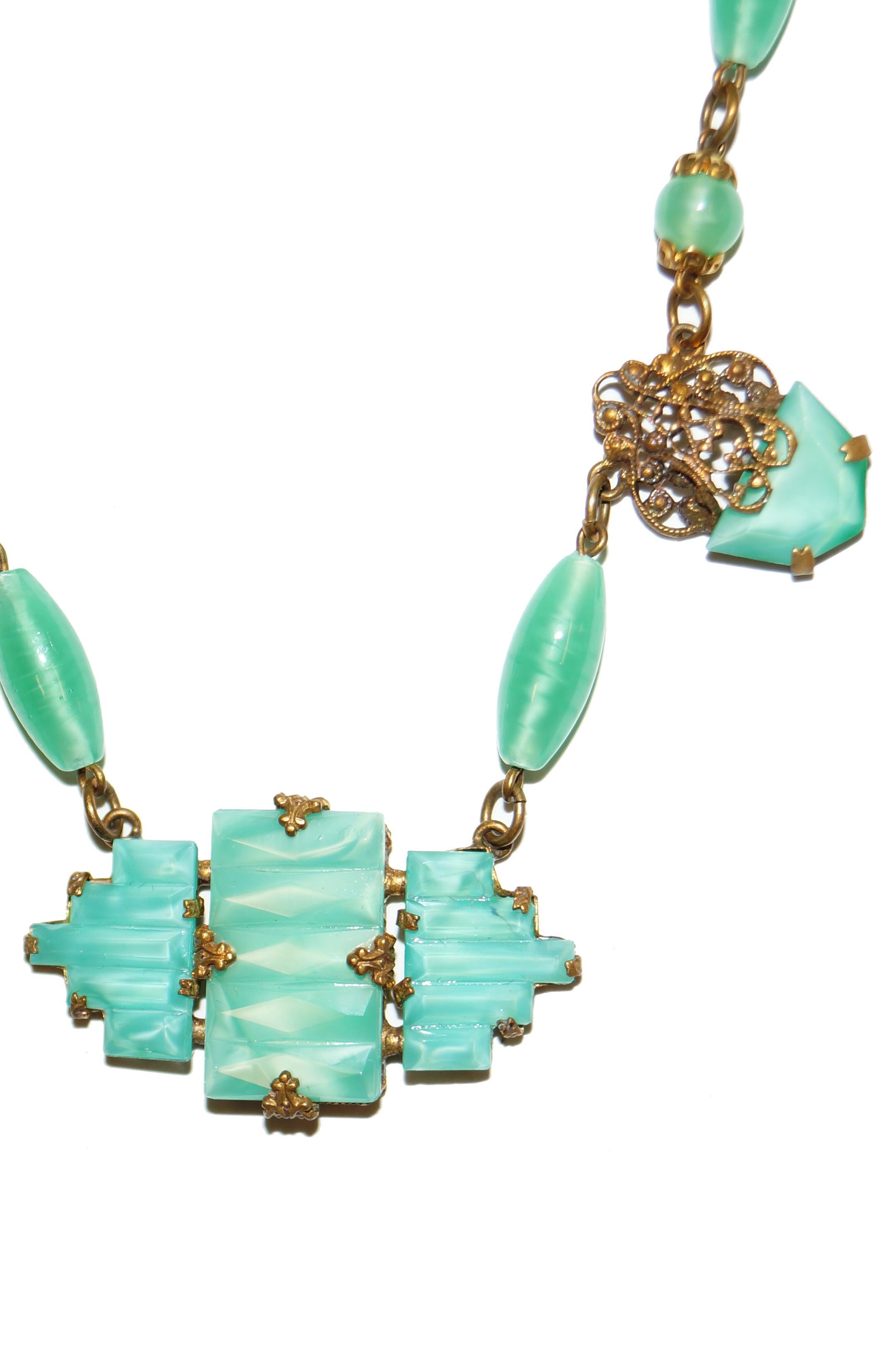 Gorgeous bold green choker necklace and earrings set made of famous bohemian glass! The dangling earrings are composed of a bold rectangular glass beads anchored by baroque swirls beset with milgrain details. The necklace has a center focus of three