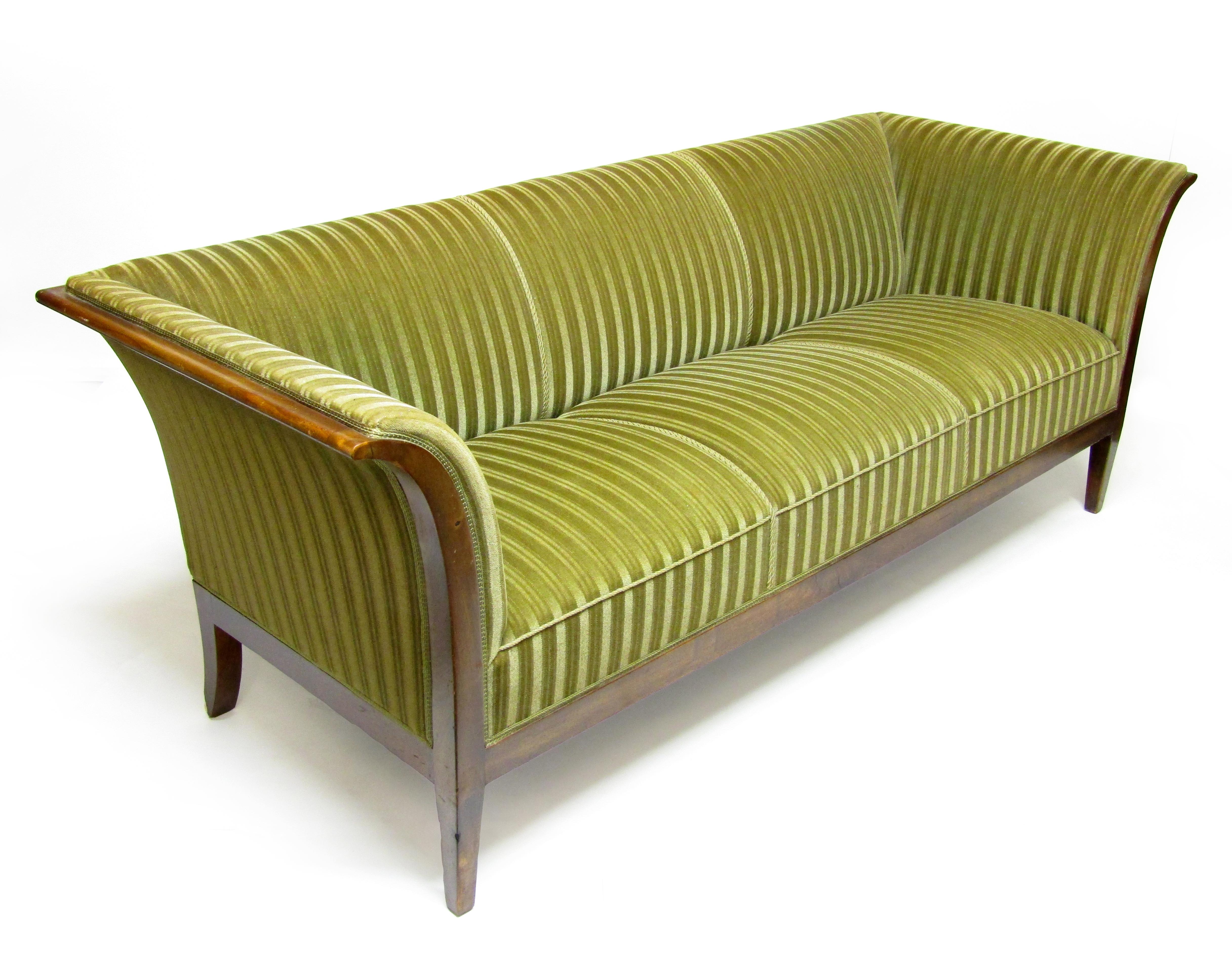 A striking 3-seater sofa in Cuban mahogany and green velvet fabric by Frits Henningsen.

In competition with his teacher Kaare Klint, Henningsen was one of the outstanding Danish designers of the early 20th century. A central aim was to modernise