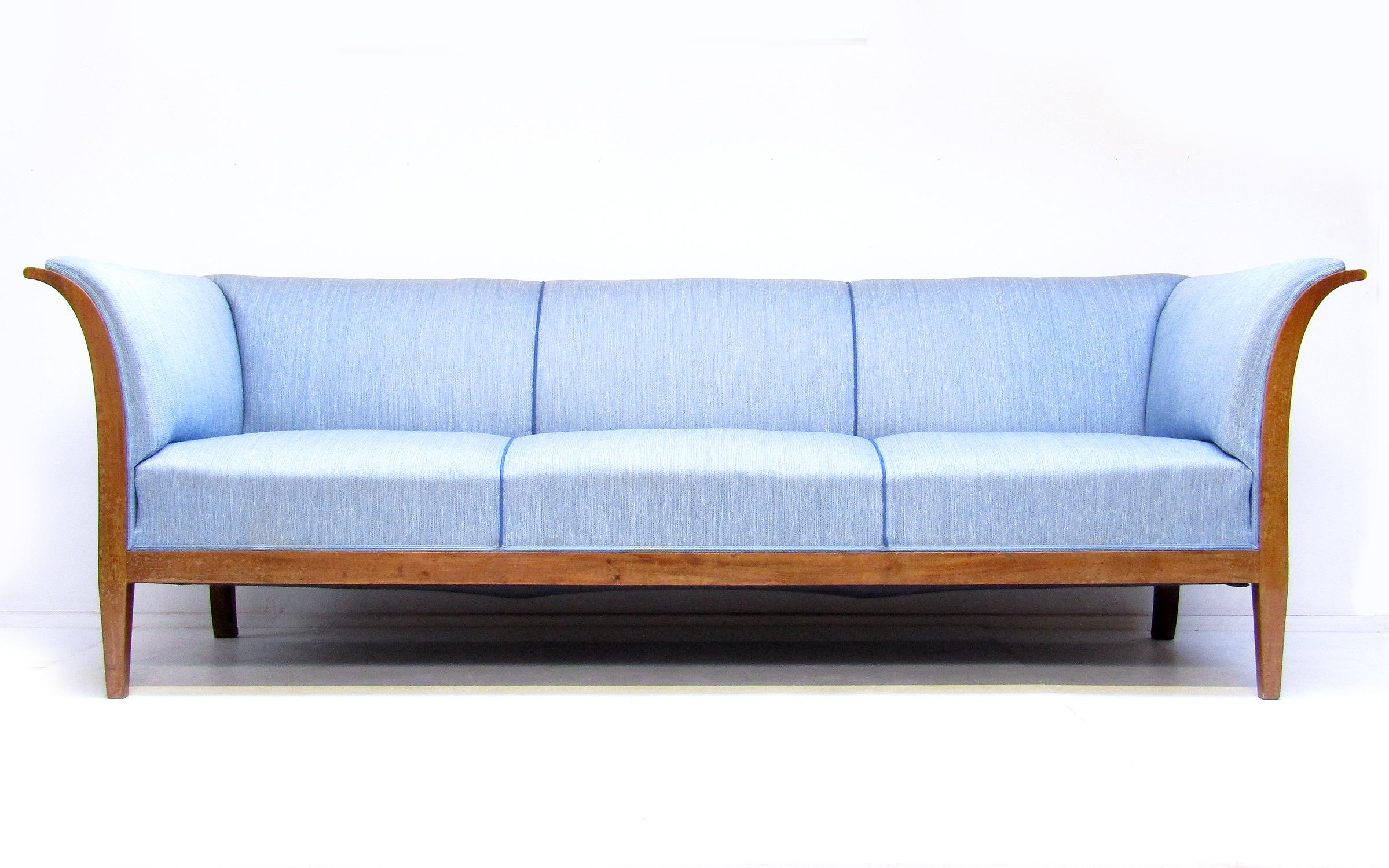 A striking 3-seater sofa in Cuban mahogany and pale blue fabric by Frits Henningsen.

In competition with his teacher Kaare Klint, Henningsen was one of the outstanding Danish designers of the early 20th century. A central aim was to modernise and