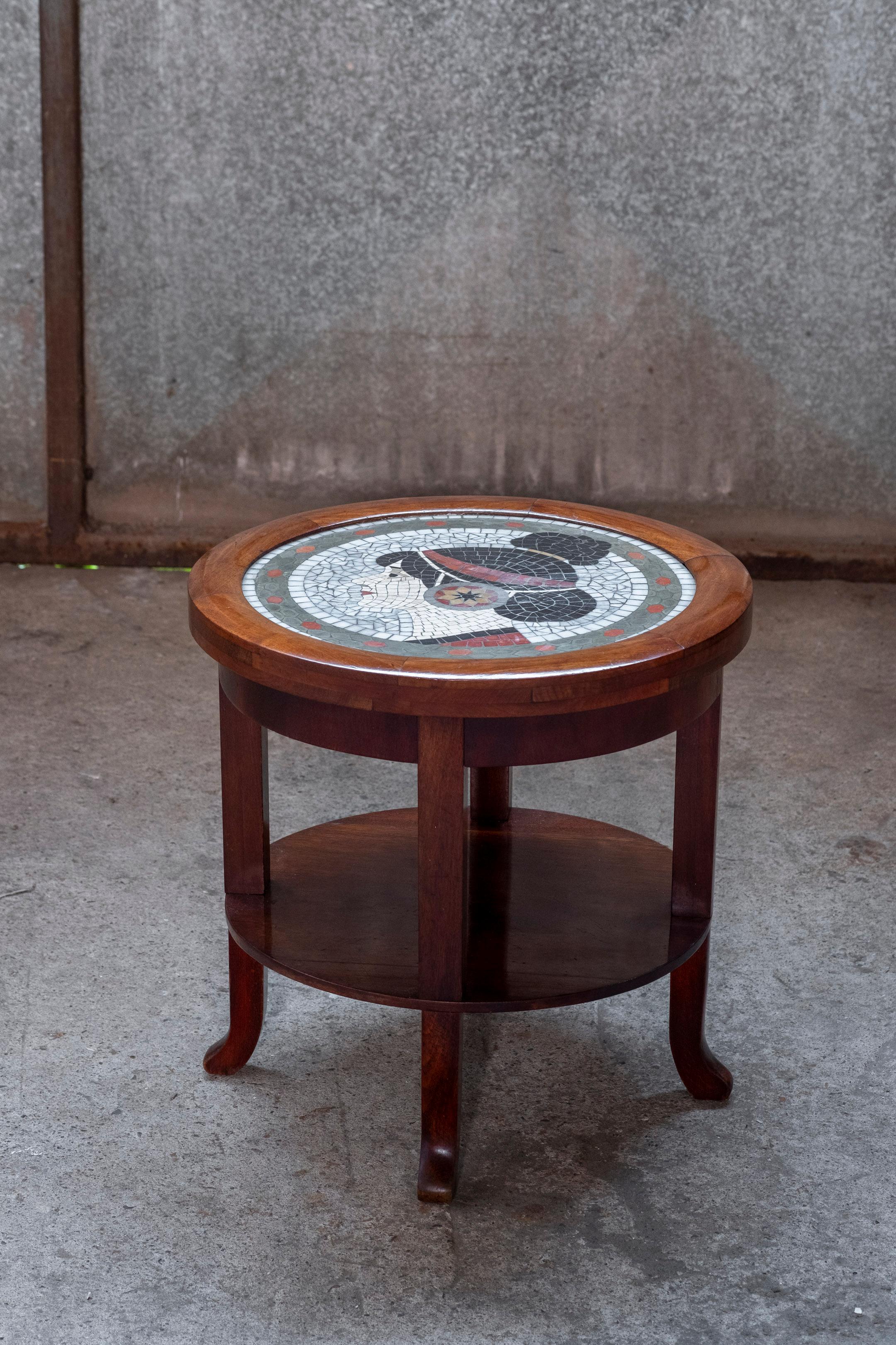 Art Deco side table made by Danish cabinetmaker and a Danish Artist in 1930s Copenhagen. Wonderfully decorated round table top depicting an exotic female portrait in handmade mosaic. The table itself is made from an amazing quality of Cuban Mahogany