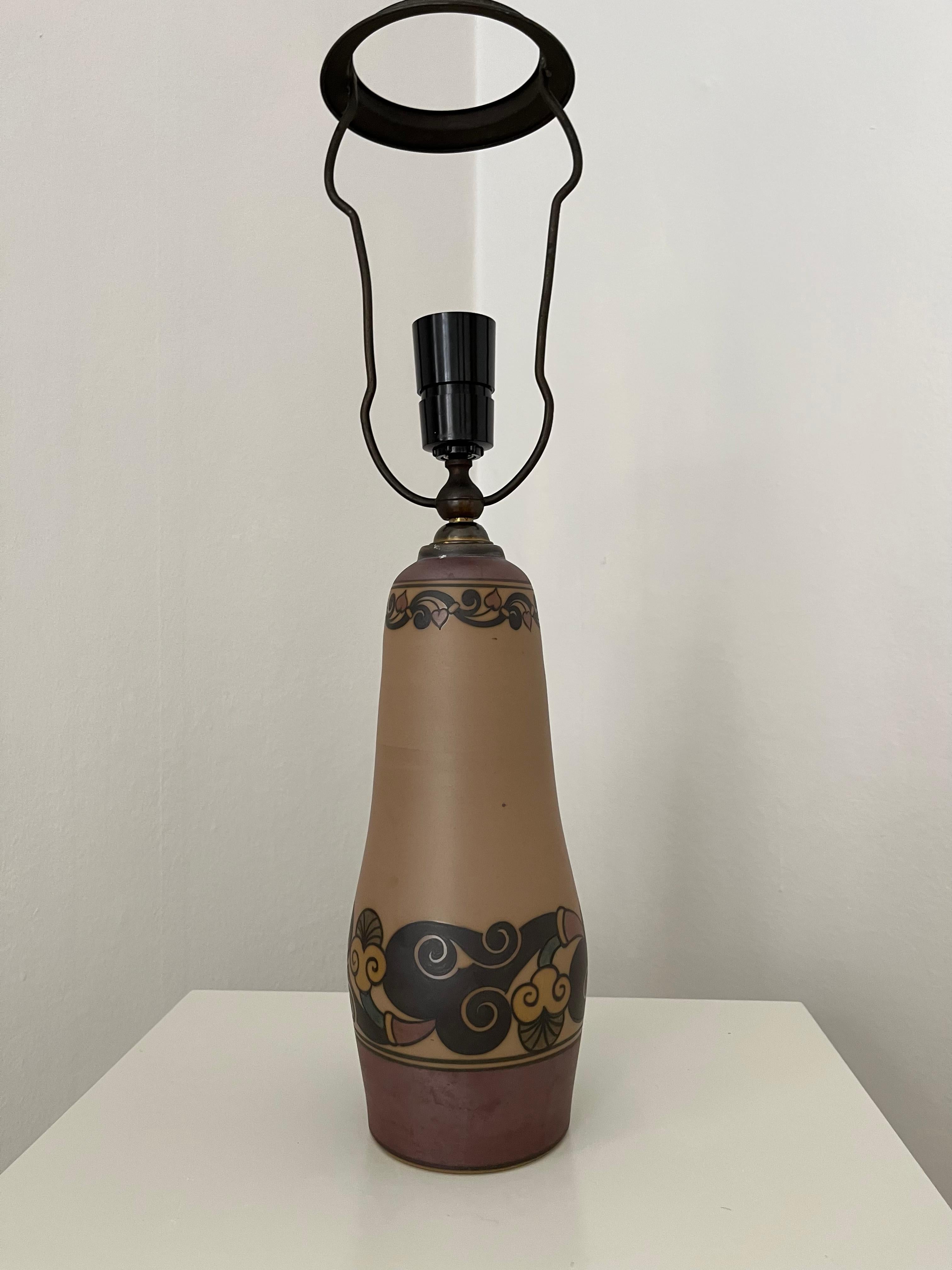 Art nouveau Danish ceramic table lamp is hand decorated, made by L. Hjort ceramic factory. This tall table lamp is from the 1930s and in very good condition. Sold without the shade.

Hjorths ceramic factory is one of the best-preserved industrial