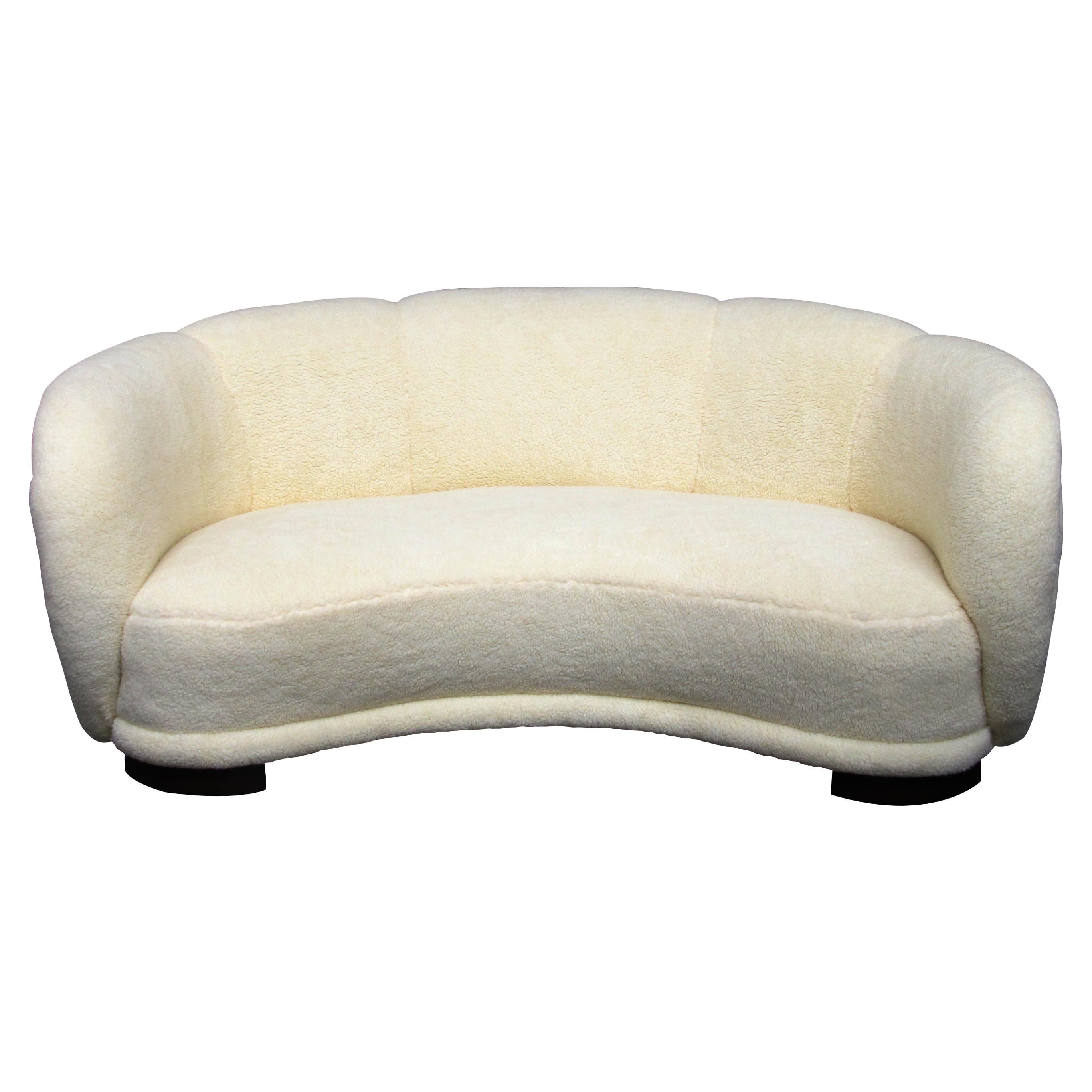 1930s Danish large curved sofa which is typical of the period with elegant and generous curves. The legs follow the shape of the sofa to achieve a continuous curved line. The sofa is very pleasing to the eye and looks stunning from every angle. This