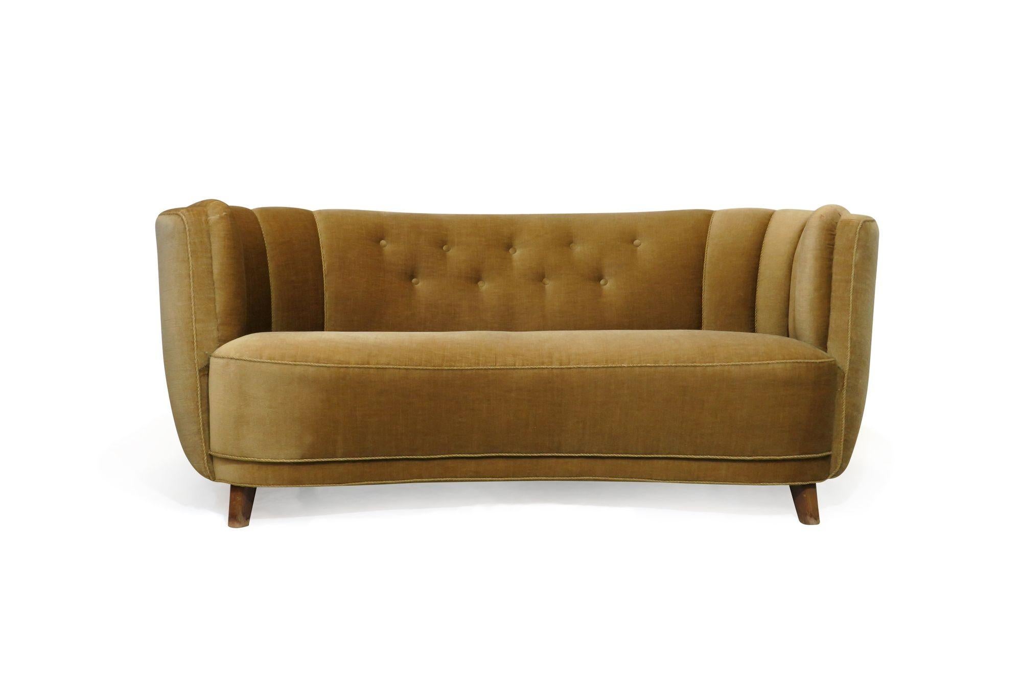 Danish channel back curved sofa circa 1930, Denmark. Sofa crafted of a solid wood frame with eight-way hand-tied springs, horsehair and cotton padding, covered in the in original light gold mohair. Good vintage condition can be used original or