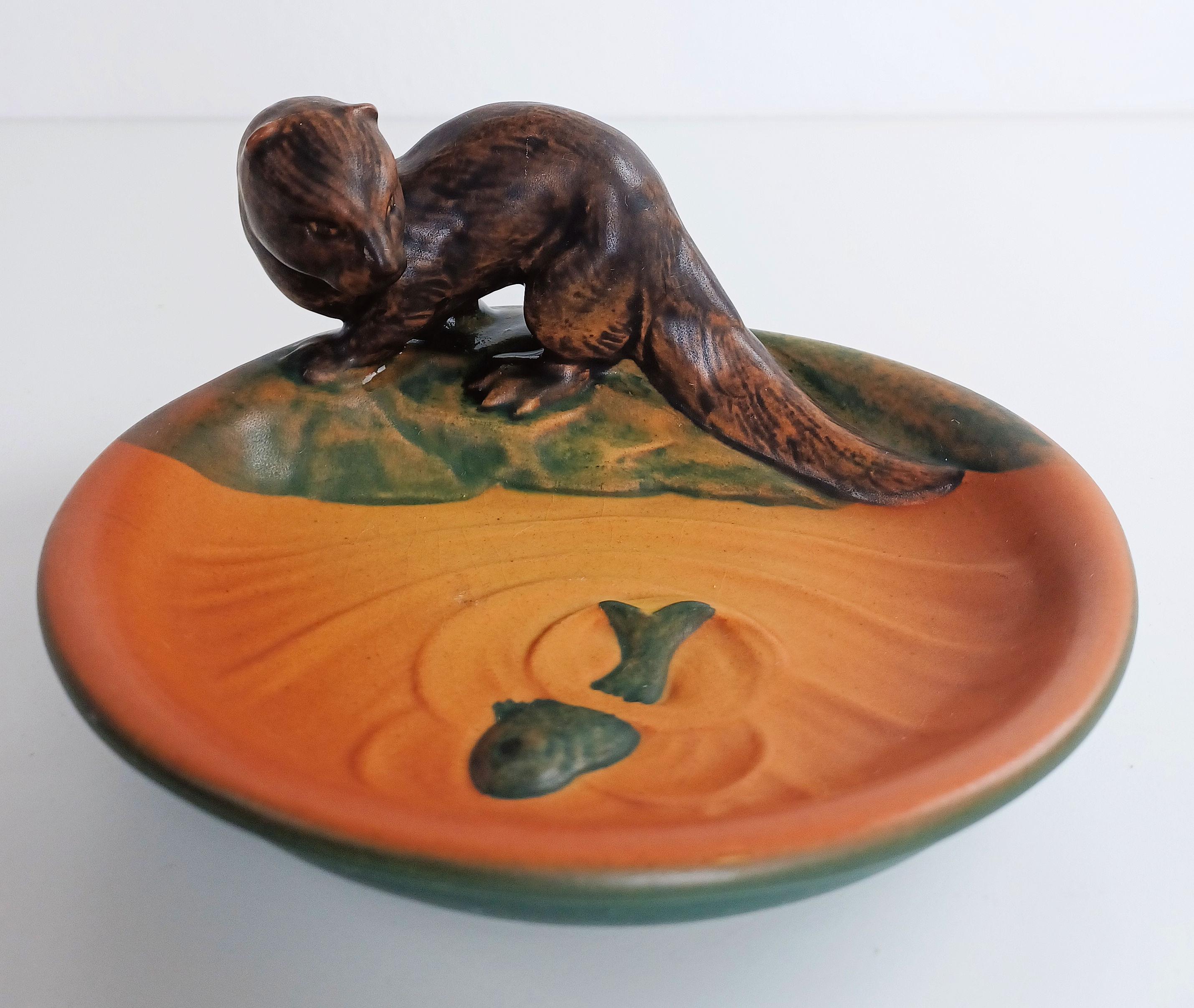 Danish hand-crafted Art Nouveau polecat ash tray / bowl by P. Ipsens Enke.

The Art Nuveau ash tray / bowl feature a lively polecat looking at a fish is in excellent condition.

Ipsens Enke (1843 - 1955) was a very successful manufacturer that