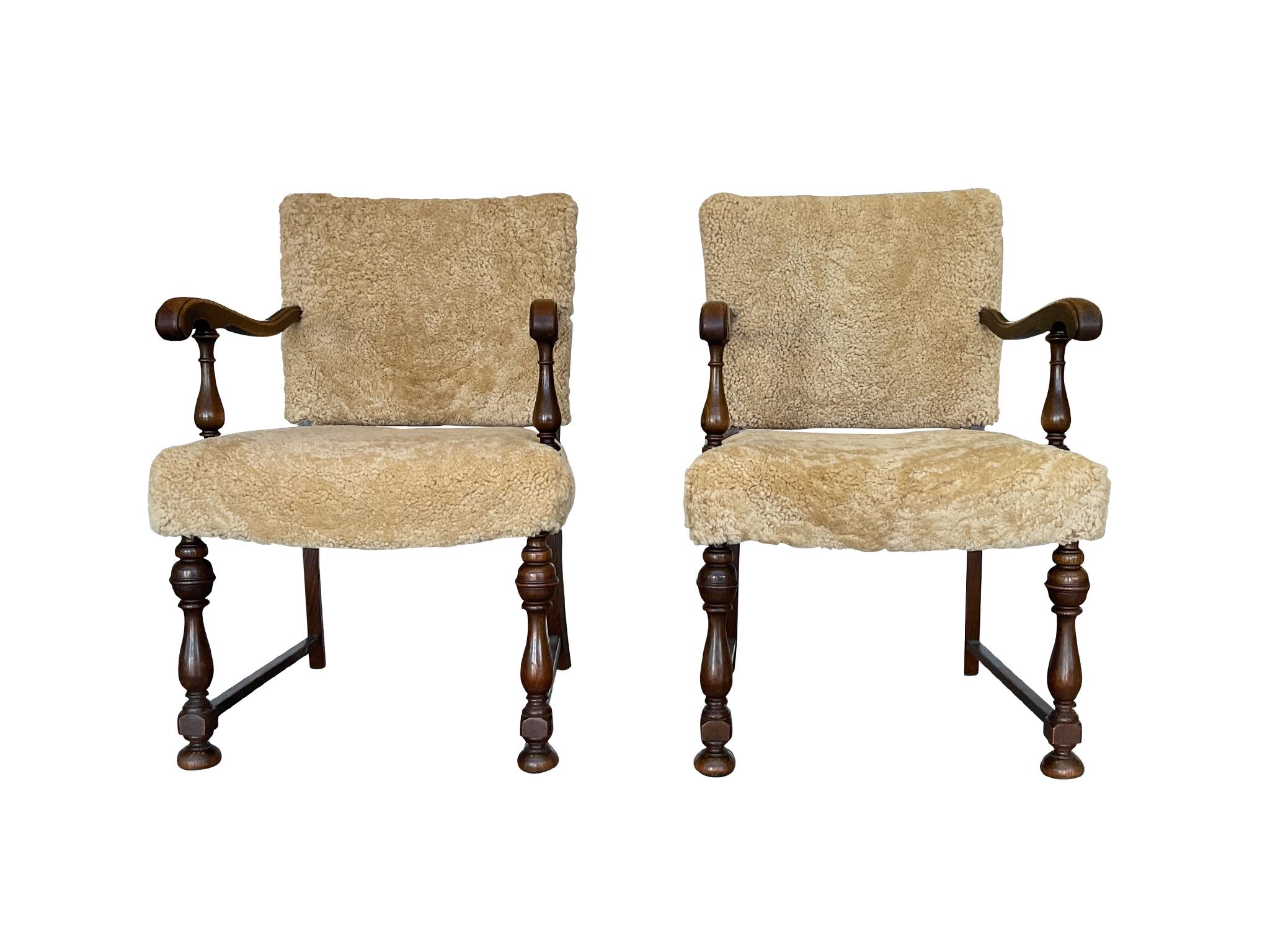 An elegant pair of Danish armchairs, hand-crafted in the 1930s from oak wood and newly reupholstered in a cozy shearling from Skandilock. The oak has a warm, reddish-brown tone that's complemented beautifully by the shearling. Structurally, the
