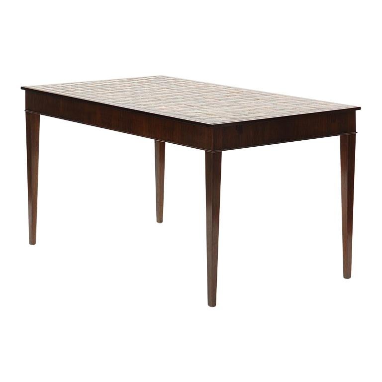 A rosewood dining table with a tiled top, tapered legs, and 2 (17.75