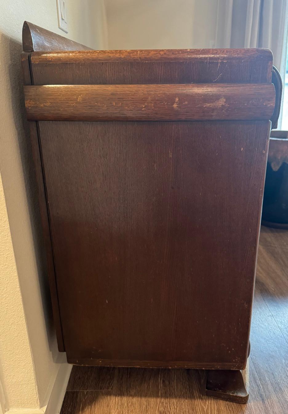 Solid oak sideboard that appears to be from the late 1920s to 1930s, likely in the Art Deco period with lingering Arts and Crafts influences.

Solid oak with a medium brown stain, showing beautiful quarter-sawn grain on the top panel.

Geometric