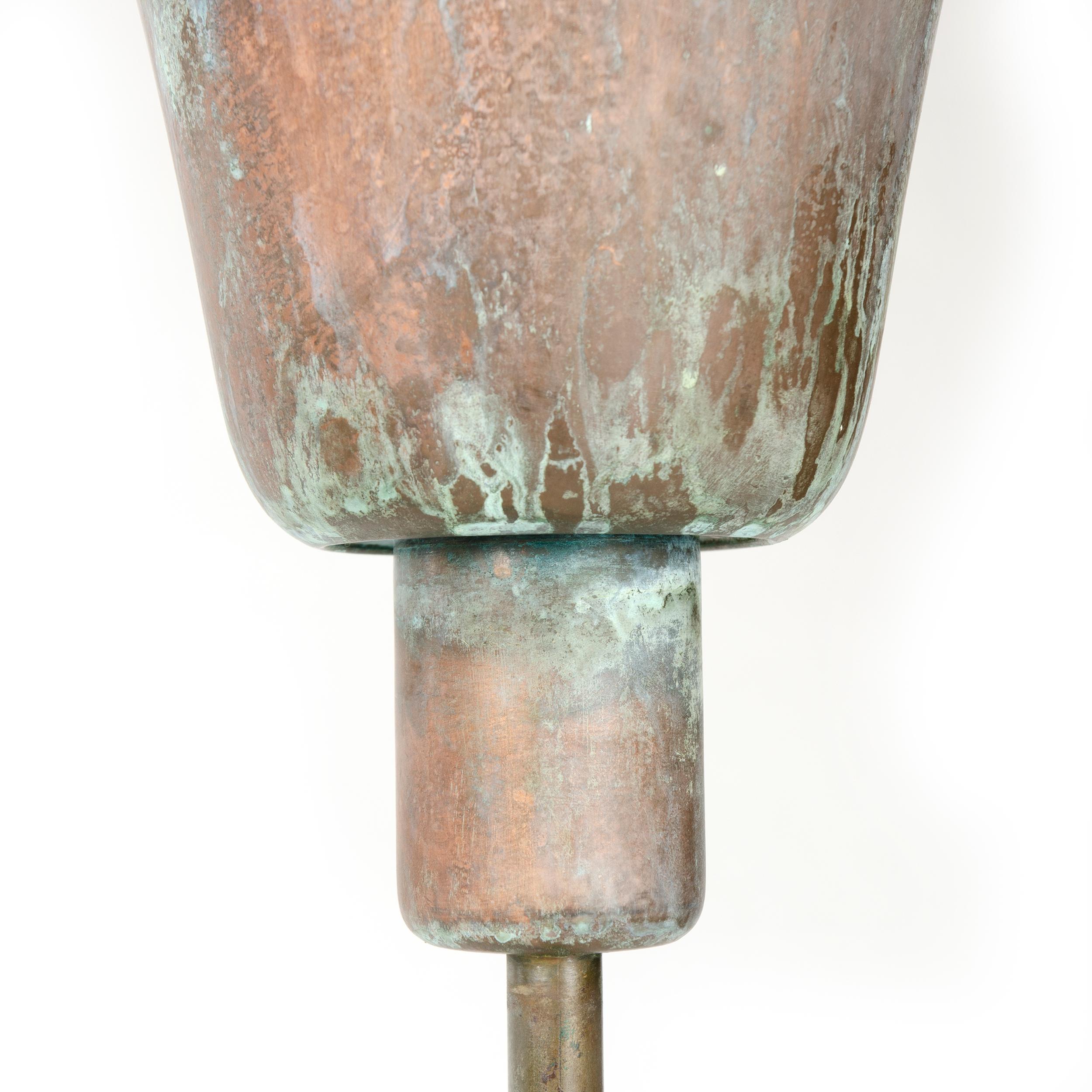 A newly patinated brass torchère uplight with funnel shaped shade atop an unadorned thin column set on a round metal base. Unmarked.