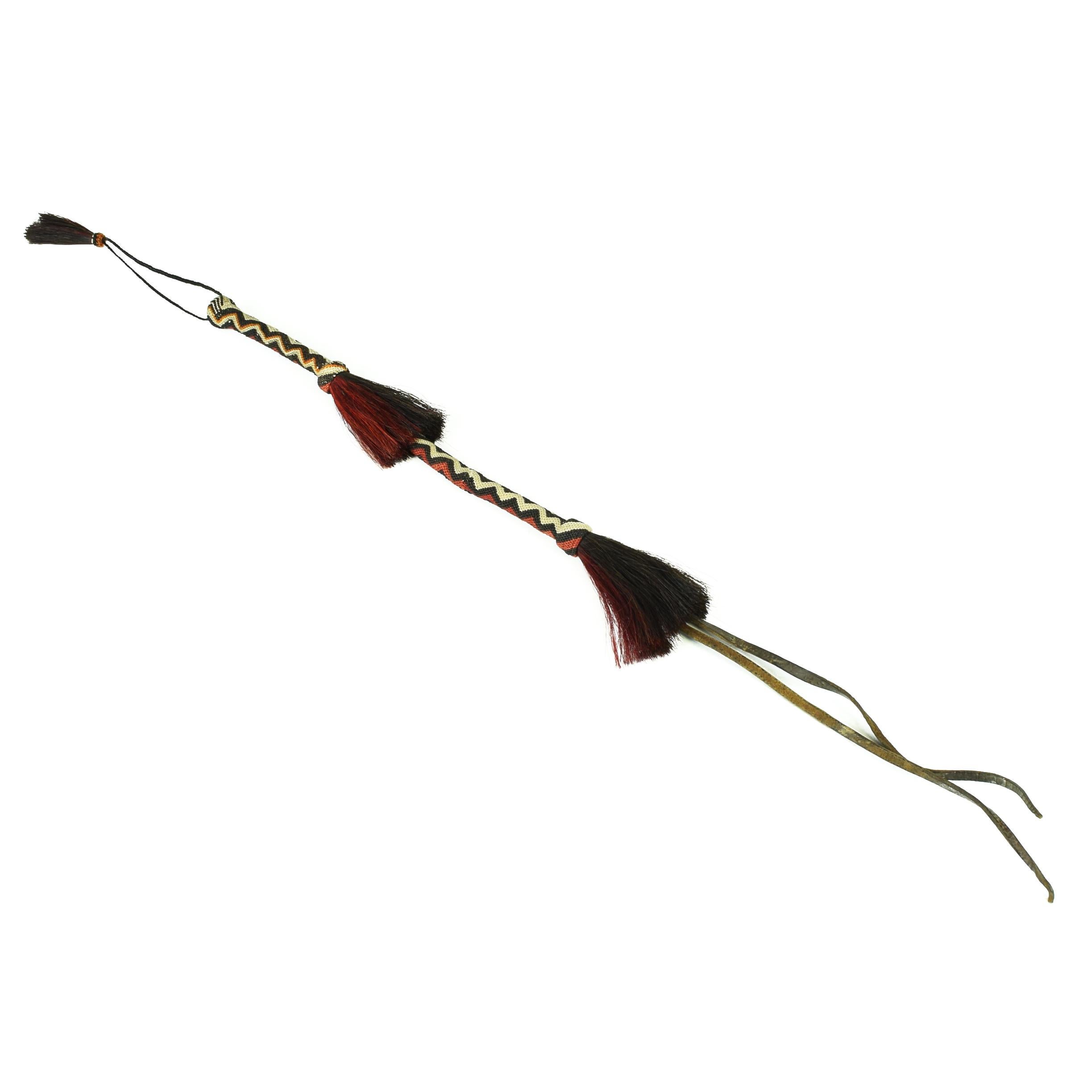 Deer Lodge Prison quirt with red, black, and white dyed horsehair and horsehair hand strap. Quirt: 16