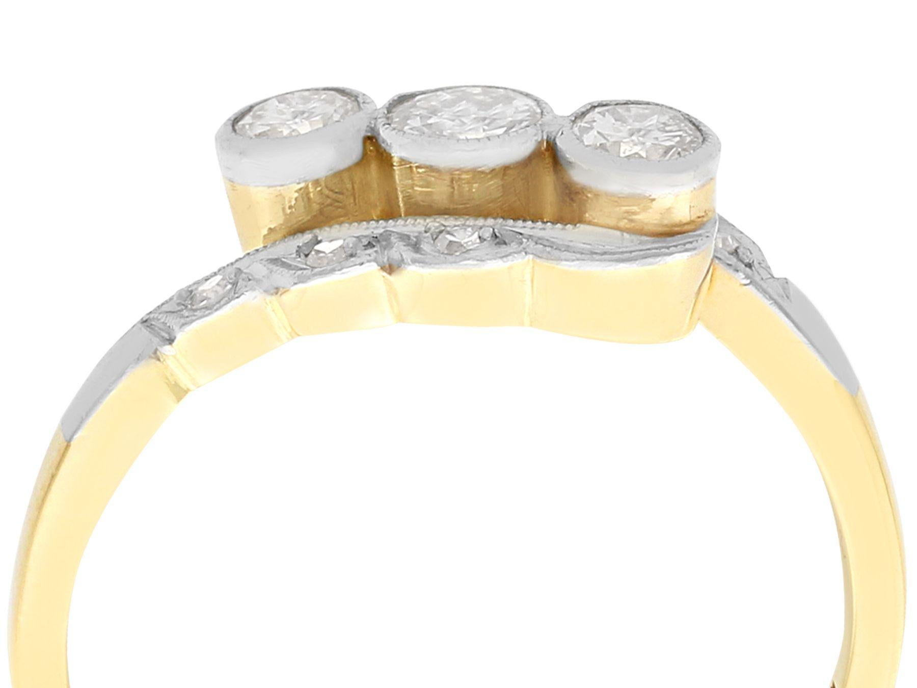 An impressive antique 0.39 carat diamond and 14 karat yellow gold and 14 karat white gold twist ring; part of our diverse antique jewelry and estate jewelry collections.

This fine and impressive three stone dress ring has been crafted in 14k yellow