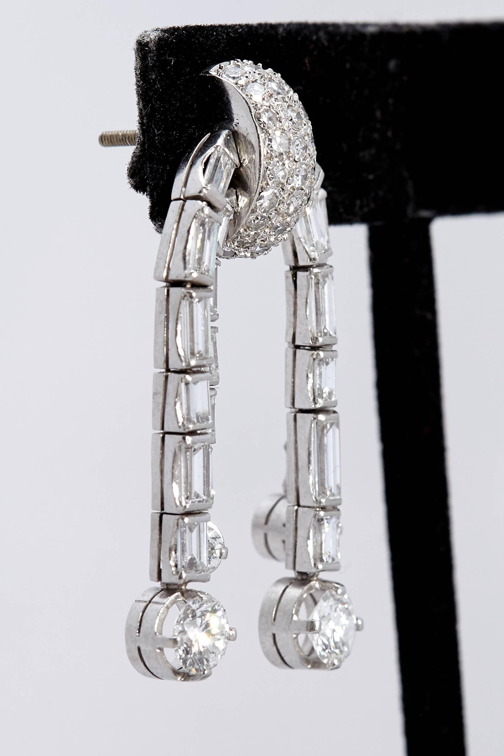 A pair of beautiful ear-pendants with baguette and round cut diamonds, mounted in platinum. Made in Italy, circa 1930s