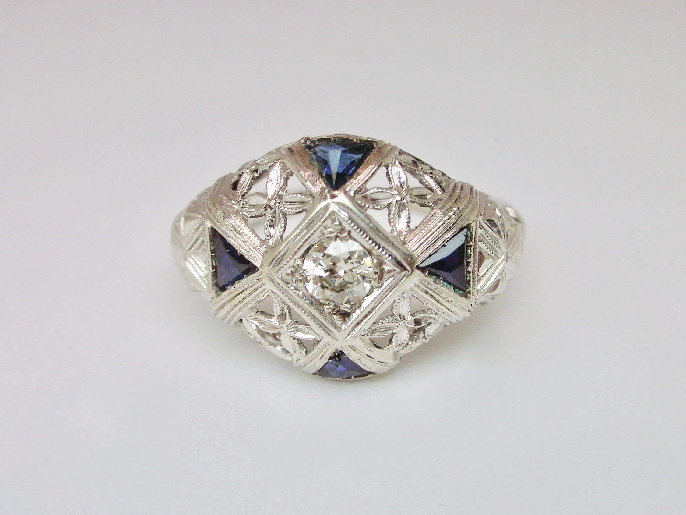 Ring from the late 1930's circa, set in white gold, with triangle cut sapphires and central old cut diamond of around 0.20 ct. 