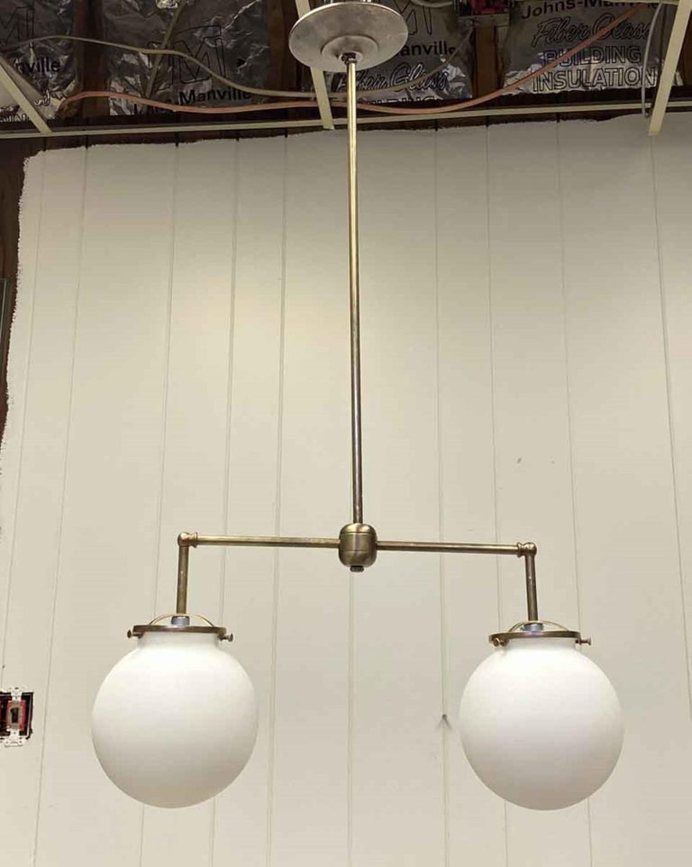 Antique two 6 inch opaline glass globes paired with newly made brass fitter. The height of pole can be adjusted upon request. Small quantity available at time of posting. Please inquire. Priced each. This can be seen at our 400 Gilligan St location