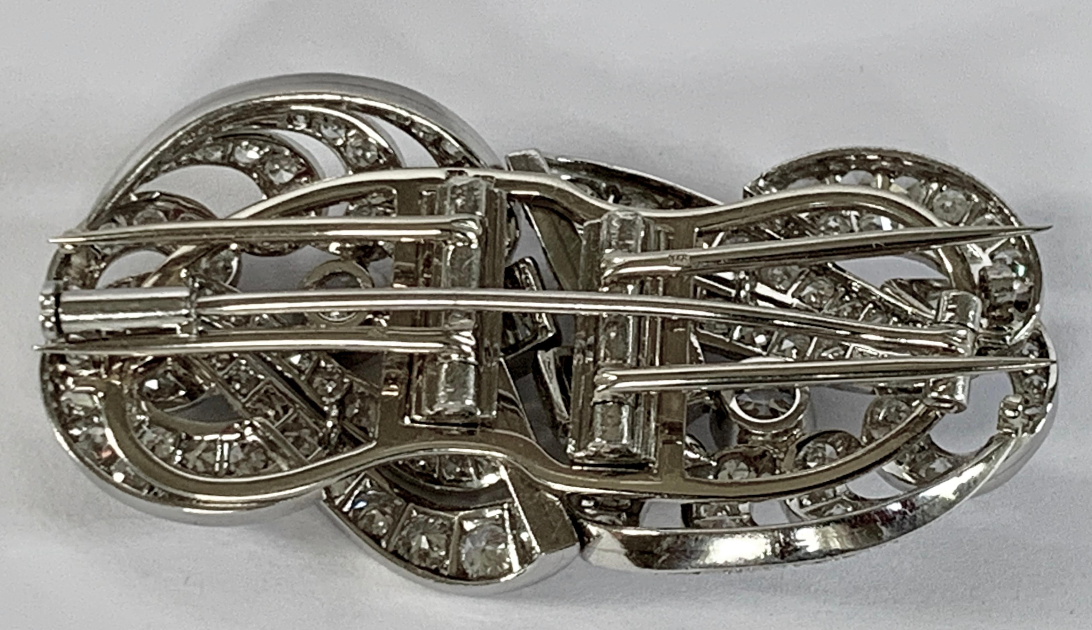 Gorgeous 1930 platinum diamond double clip brooch consisting of two symmetrical parts at the feet of each other, each part is fully embedded  with a total of 156 round brilliant cut diamonds and baguette cut diamonds of approximately 6.50 ct,