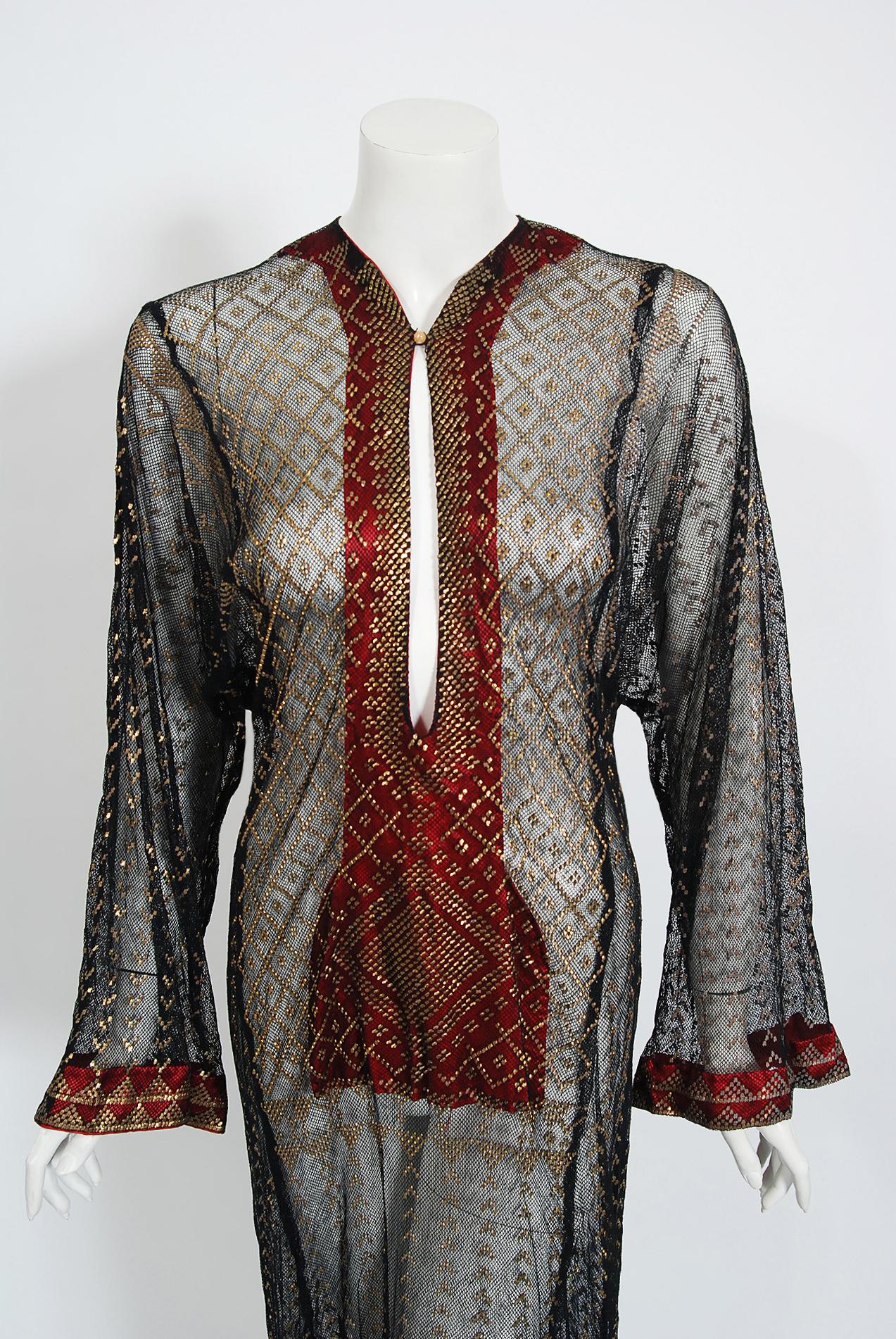 A fantastic museum-quality Egyptian assuit hammered metal cotton-net dress dating back to the early 1930's. Egyptian fashion was all the rage during the 1920's and 1930's with the discovery of King Tut's tomb. Garments made out of this fabric was
