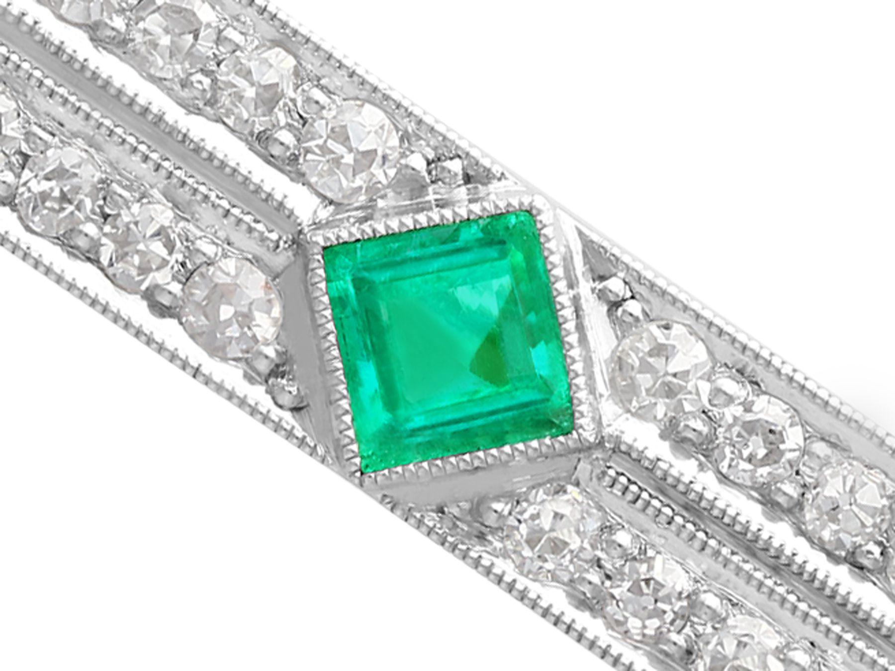 Women's Antique Art Deco Emerald and 1.29 Carat Diamond Platinum Brooch For Sale