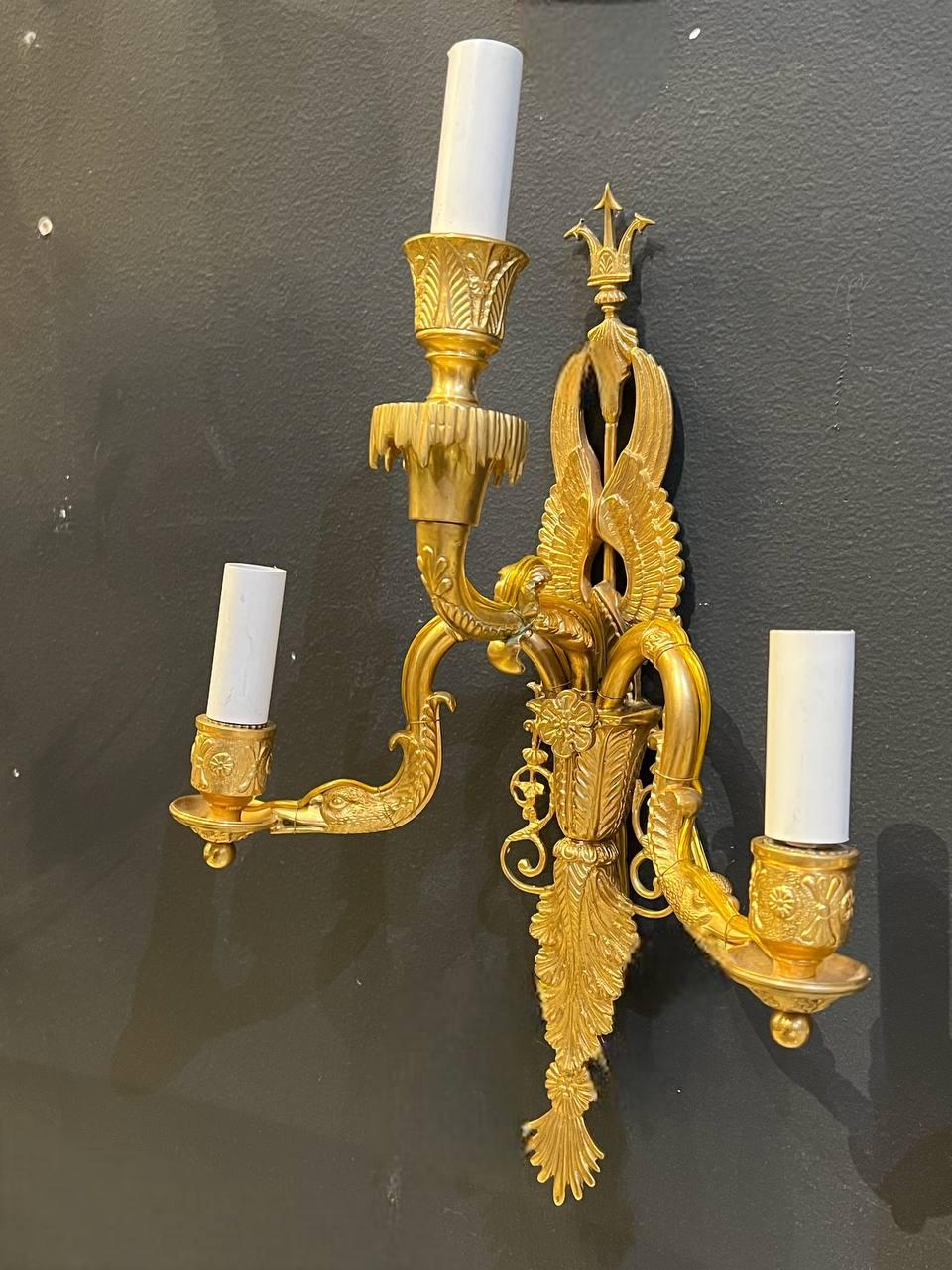 A pair of 1930’s gilt bronze sconces with swan’s head and three lights