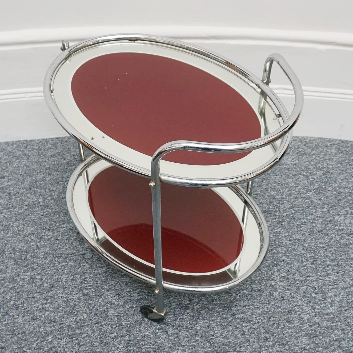 An Art Deco Chromed metal drinks trolley with two tiers of red tinted mirrored glass. Set on original castors. 

Dimensions: H 63cm W 68cm D 46cm 

Origin: English

Date: Circa 1935

Item Number: 2810228