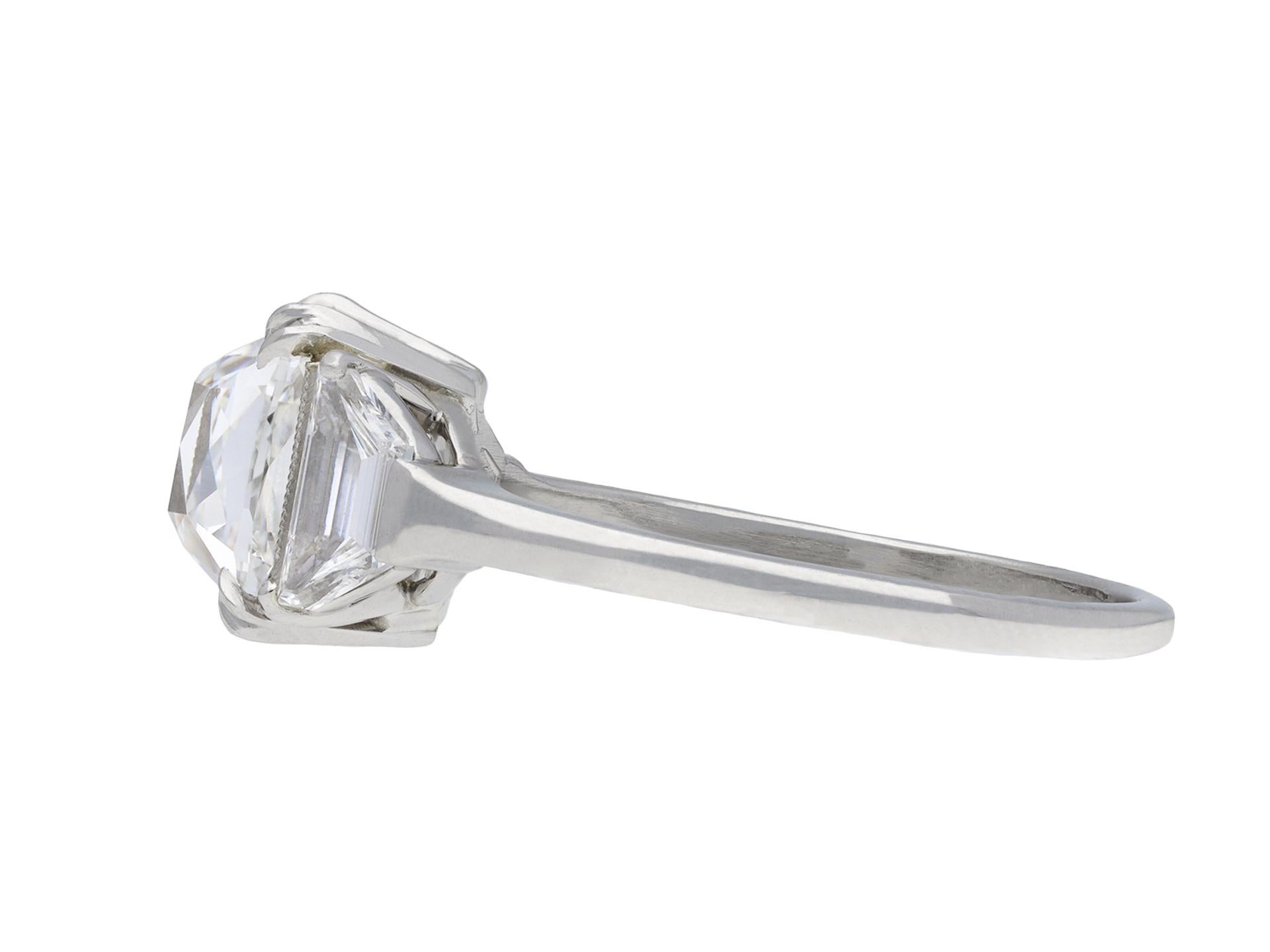 Art Deco old mine diamond solitaire ring. Centrally set with a cushion shape old mine diamond, G colour, VS1 clarity in an open back fancy claw setting with a weight of 3.01 carats, further enhanced by two tapered baguette cut diamonds in open back