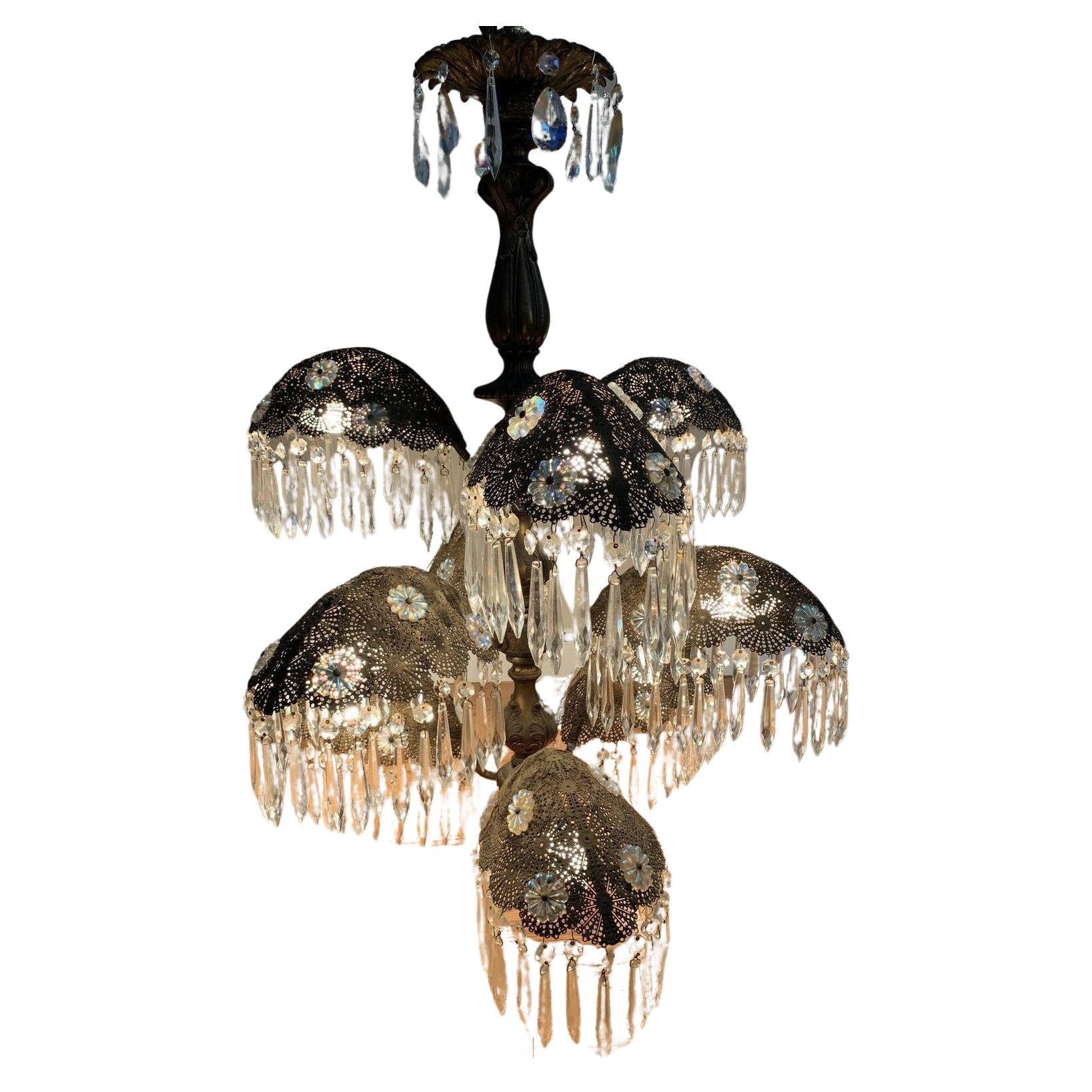 This is an outstanding 1930s European Art Deco Palm Frond Chandelier adorned with Cut Crystal U-Drops and Aurura Borealis Rosettes. Ornate filigree palm fronds. This chandelier was purchased at an estate sale on Miami Beach. 