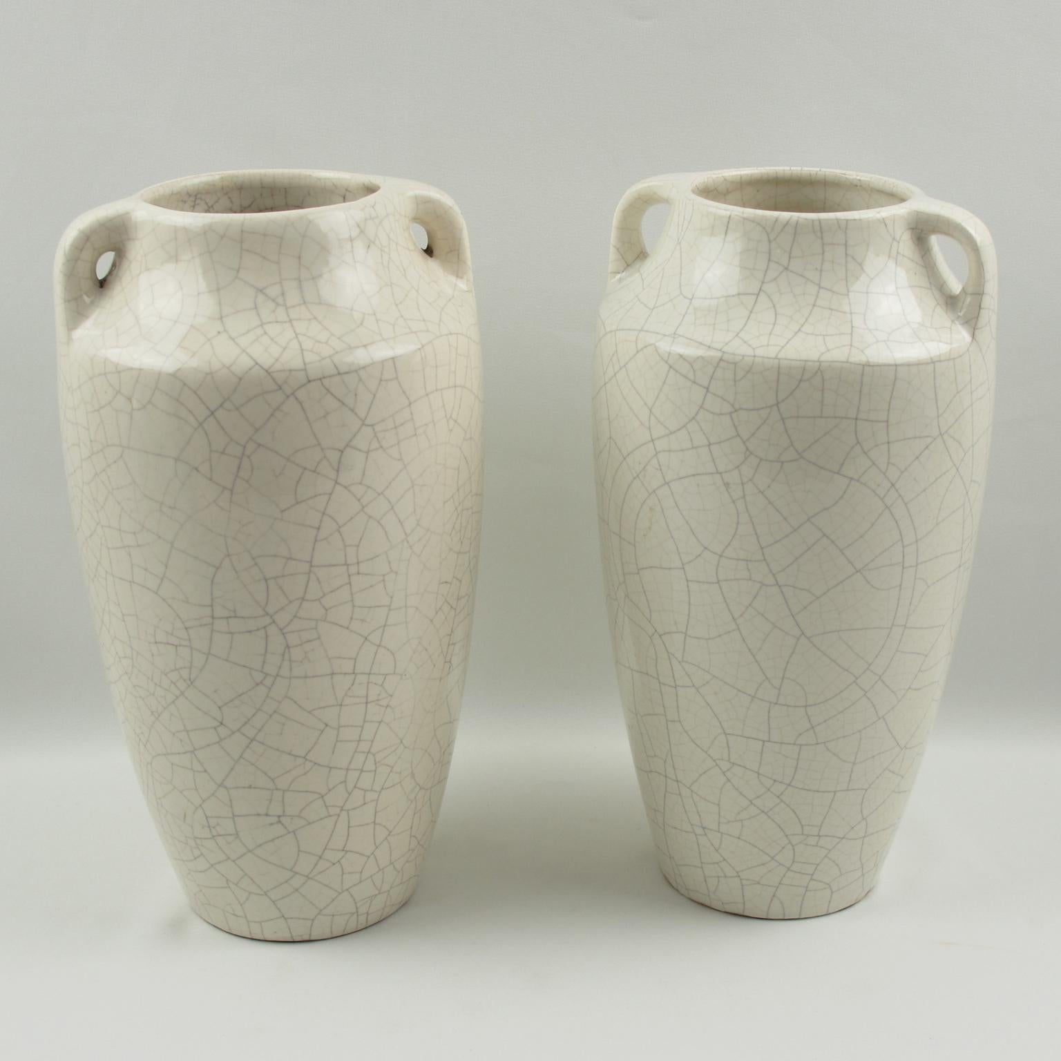 Elegant pair of Art Deco vases by Faiencerie Saint Clement. French ceramic vases with white crackle glaze finish. Features an impressive Amphora shape with two small handles. The crackle clear glaze was a popular technique for animal and figural