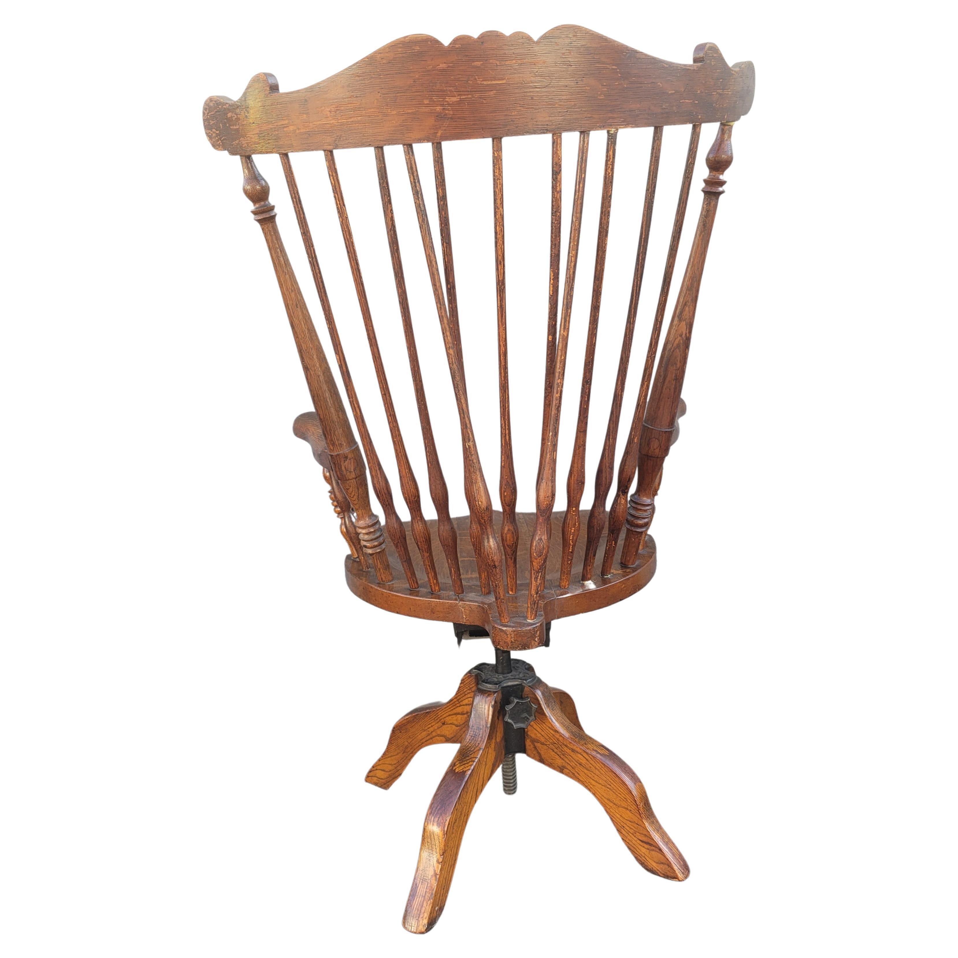 Edwardian 1930s Fiddleback Oak Windsor Style Tilting and Rolling Desk Chair W/ Saddle Seat For Sale