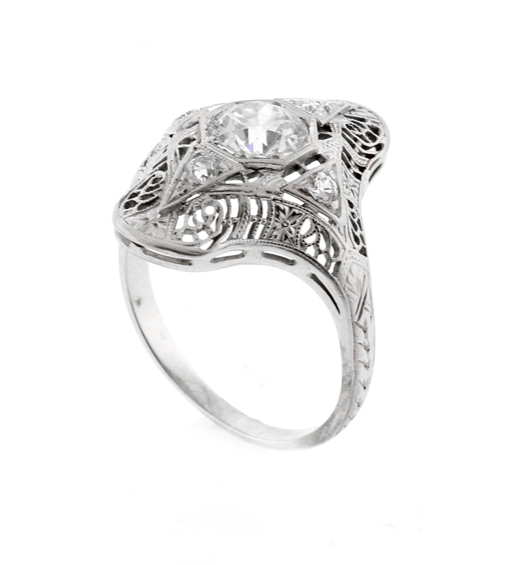 A highly detailed filigree platinum diamond ring from the 1930s
♦ Metal: 18 karat white
♦  Old European cut diamond=.85 carats H color, VS2 clarity
♦ 4 Diamonds=.15 carats
♦ Circa1930s
♦ Size 6½, Resizable
♦ Packaging: Pampillonia presentation box